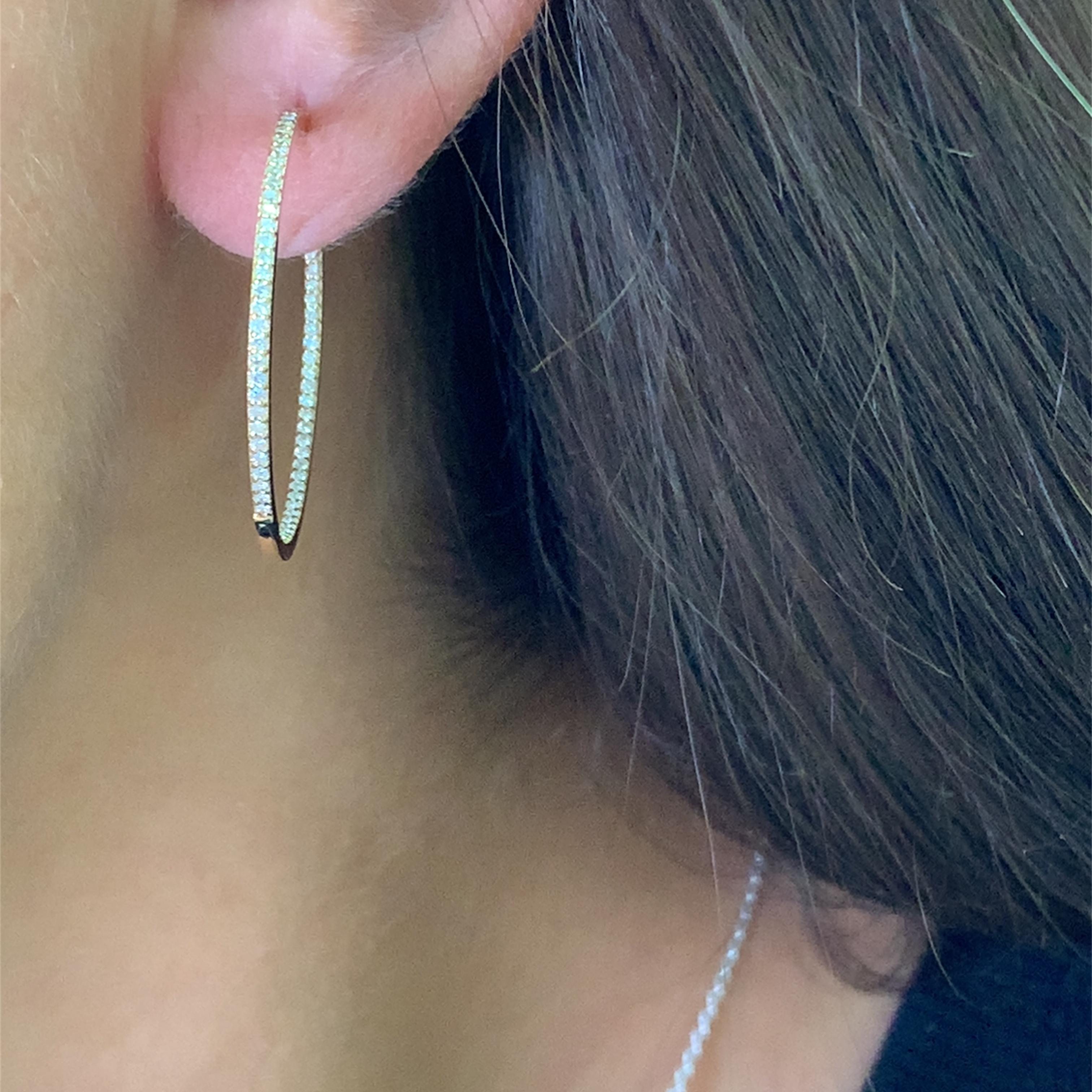 Elegant diamond 18k yellow gold hoop earrings featuring brilliant-cut round diamonds. These timeless earrings showcase a harmonious composition and sparkling diamonds that add a touch of sophistication to any ensemble. Diamond weight 0.40ct F VS1,