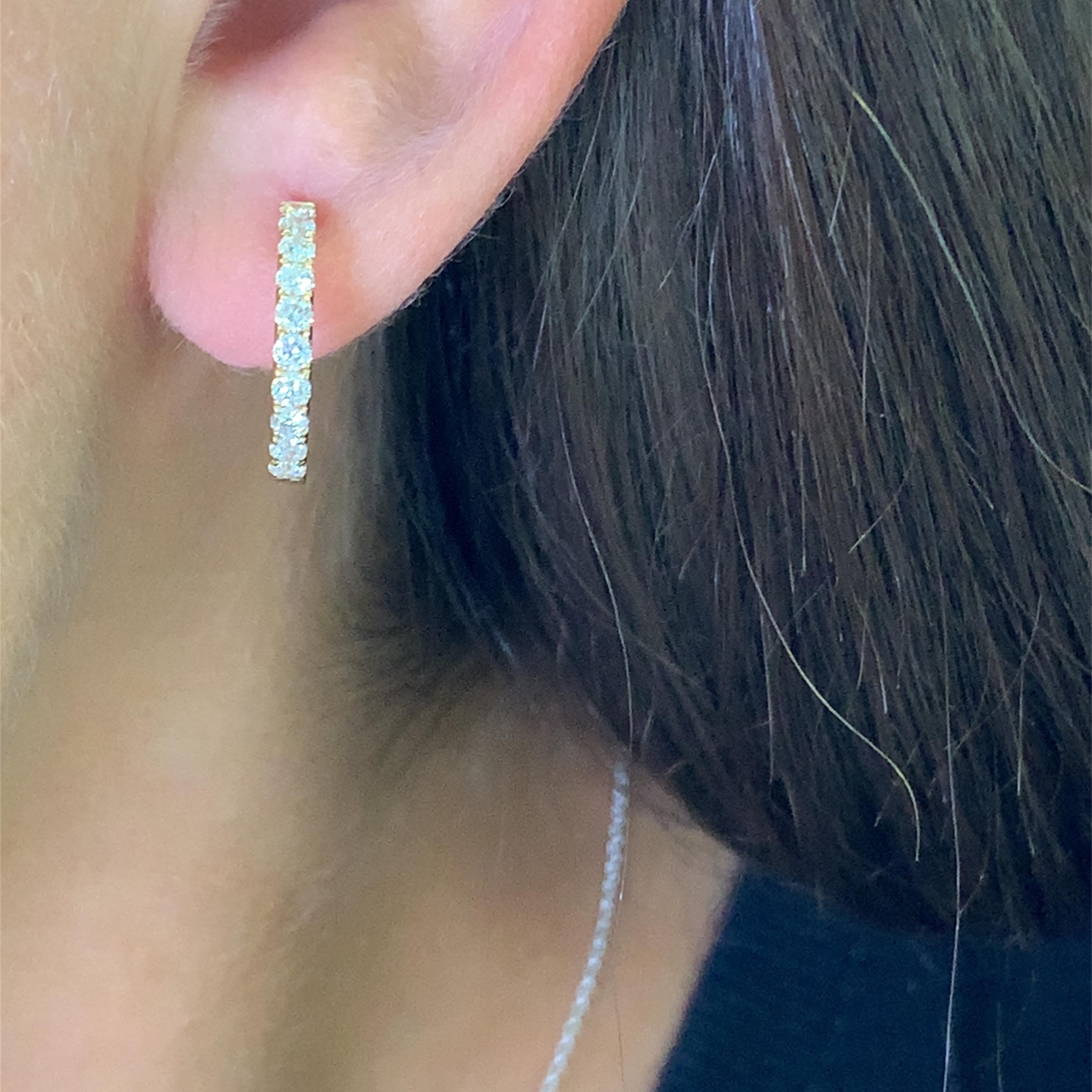 Elevate your everyday style with these stunning 18k gold hoop earrings. Each earring is meticulously set with round brilliant cut diamonds, offering unparalleled sparkle and sophistication. These earrings seamlessly blend classic design with modern