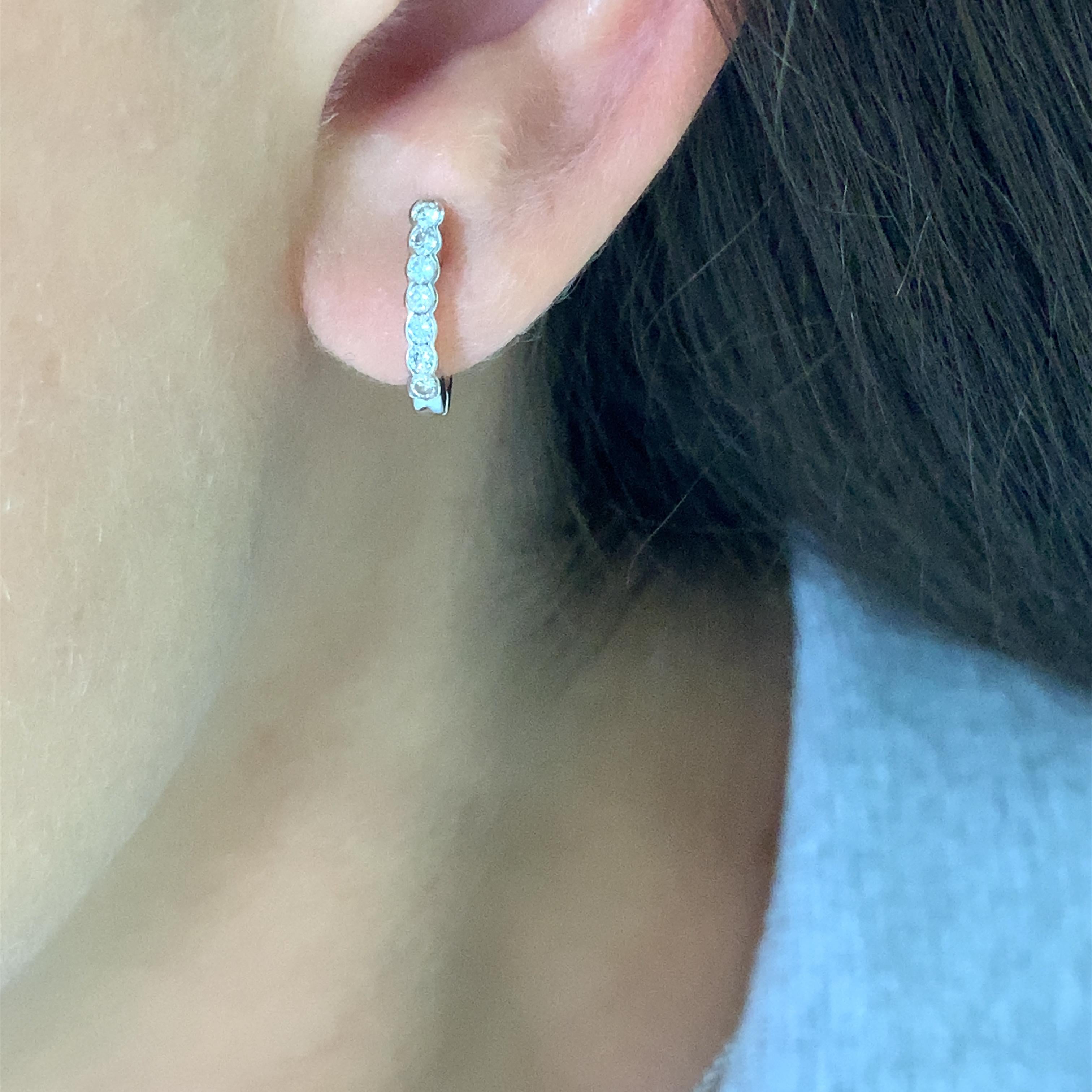 Round diamond hoop earrings in 18k white gold.
Classic round diamond cut hoop earrings with bezel setting all mounted in 18k white gold.
Round diamond cut total weight approximately 0.80ct F VS1 
Accompanied by valuation 