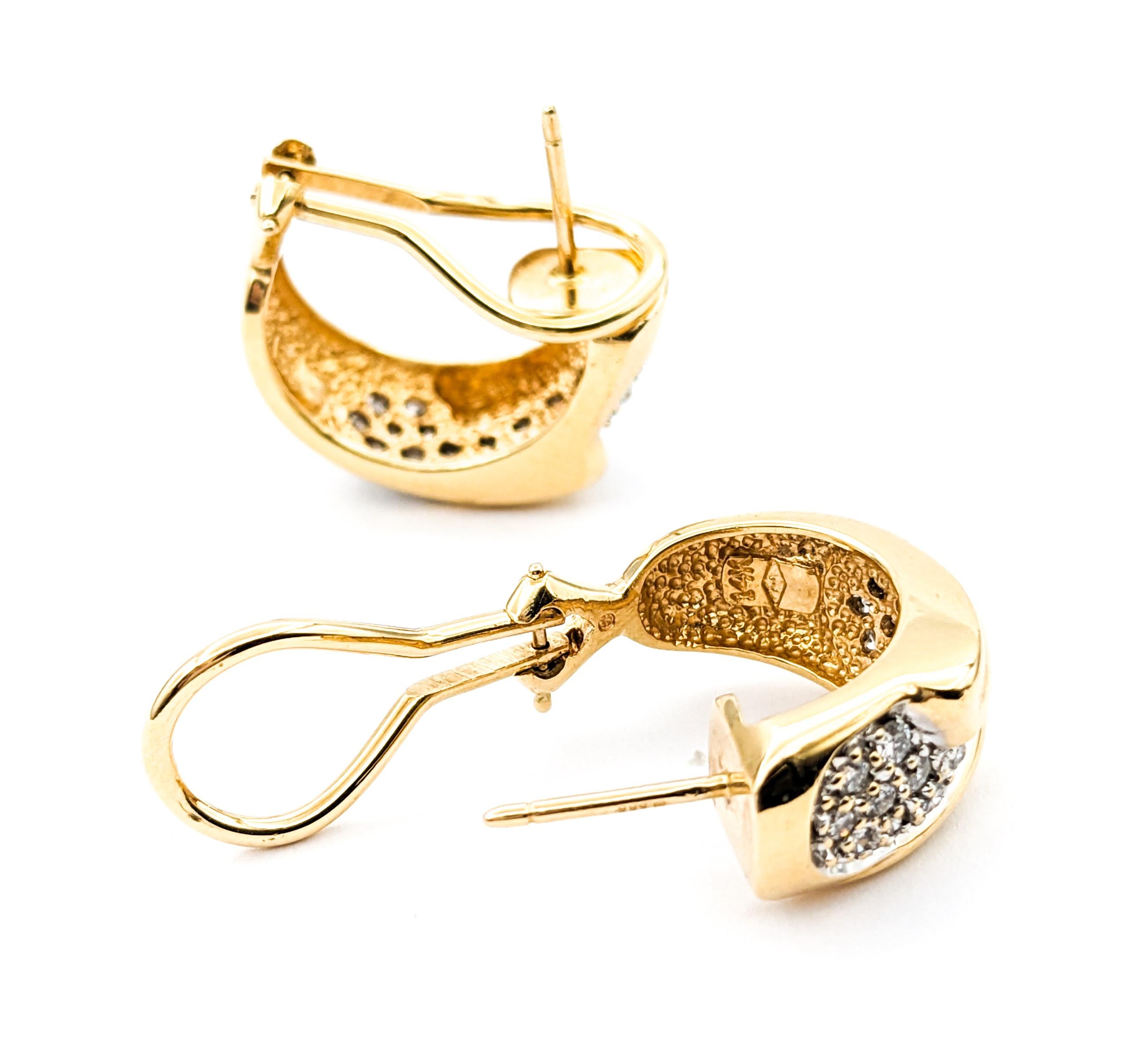 Diamond Hoop Omega Back Earrings In Yellow Gold

Introducing these luxurious pave diamond fashion earrings crafted in 14kt yellow gold. These stunning earrings feature .50ctw of round diamonds with SI clarity and a near colorless hue, set in an