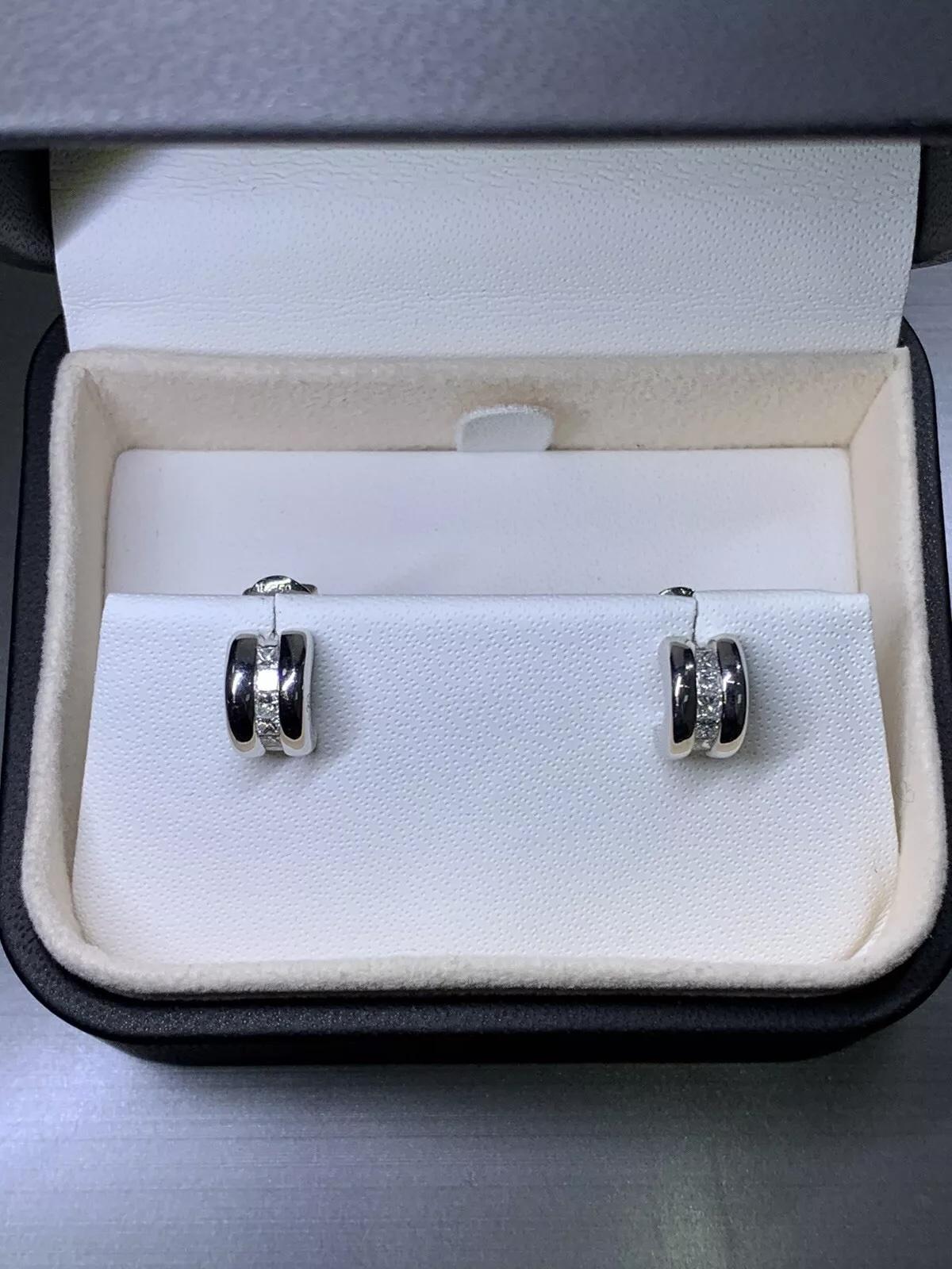 Add a touch of elegance to your style with these stunning Diamond Hoop Stud Earrings. Crafted with 18ct white gold, these earrings feature a round shape, butterfly closure, and a total carat weight of 0.78ct. The princess-shaped main stone and the