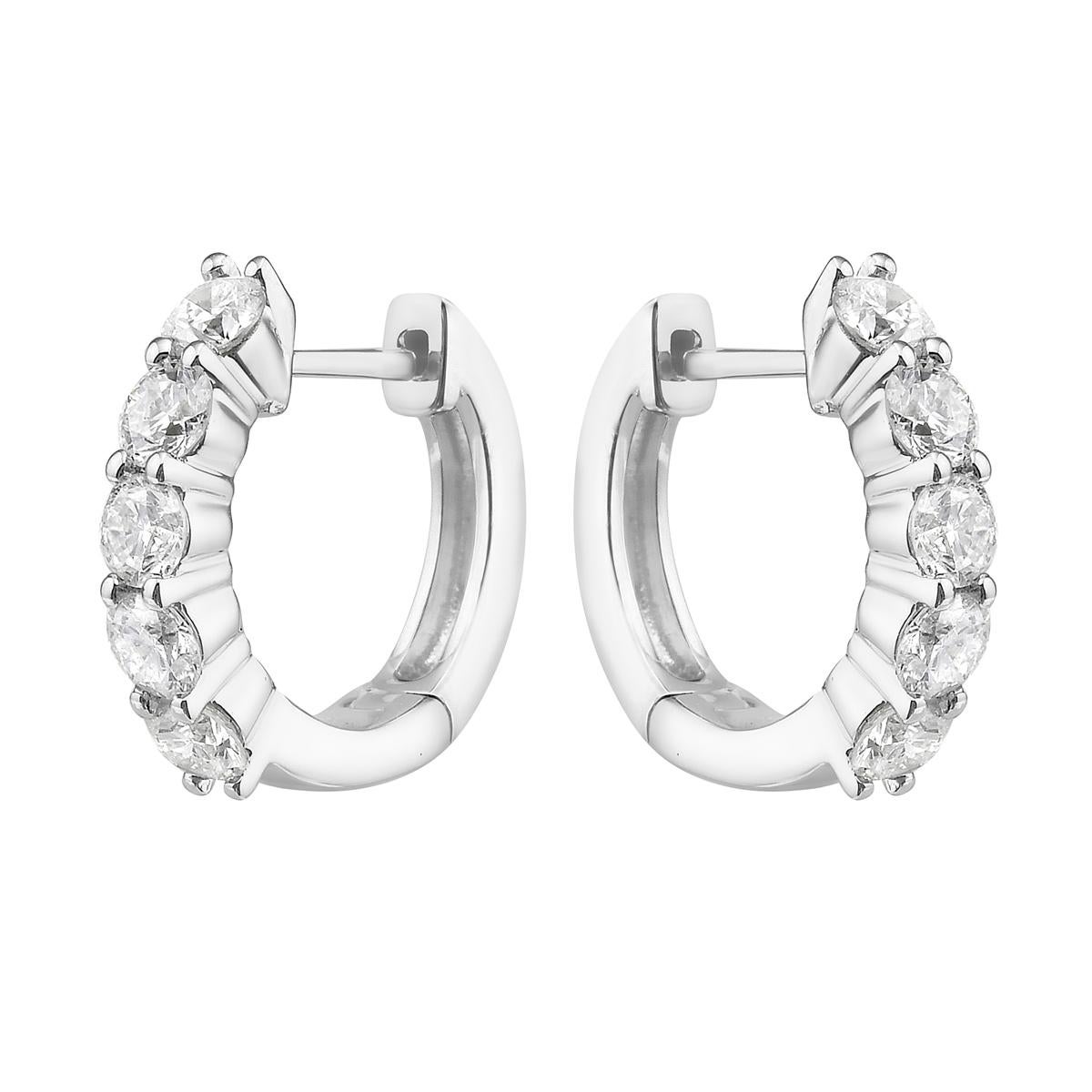 With these exquisite white-gold diamond hoops, style and glamour are in the spotlight. These hoops are set in 14-carat gold, made out of 3.4 grams of gold. The color of the diamonds is GH. The clarity is SI1-SI2. These earrings are made out of 10
