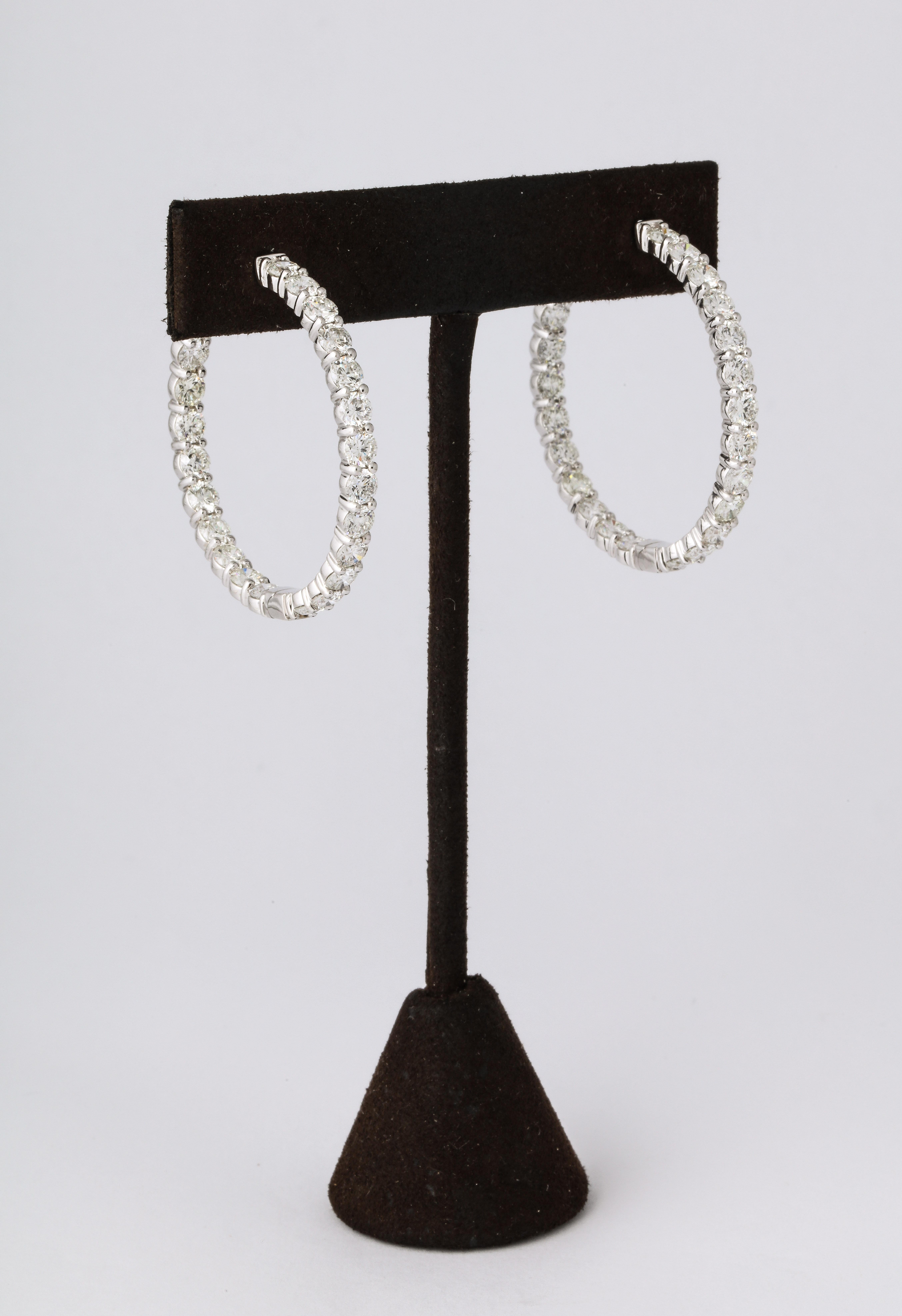 
A beautiful pair of classic diamond hoops.

8.83 carats of white round brilliant cut diamonds set 