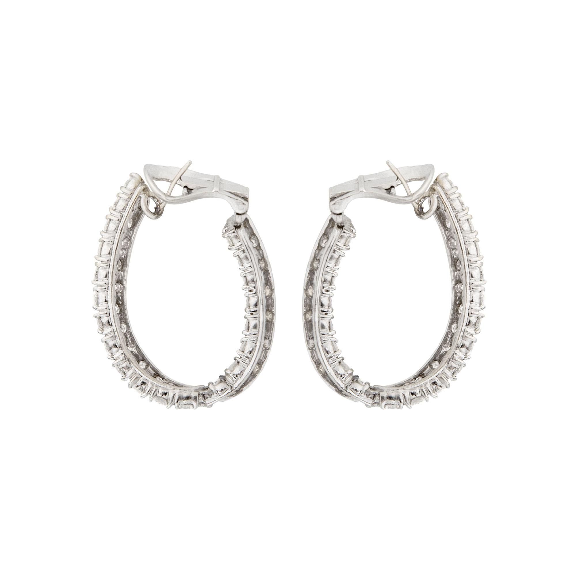 The best kind of hoops!

These elongated hoop earrings are set “in and out” with double rows of brilliant-cut diamonds

1-1/2 inch in length
80 brilliant round cut diamonds total approximately 13.60 carats
18k white gold
Posts and omega clip backs