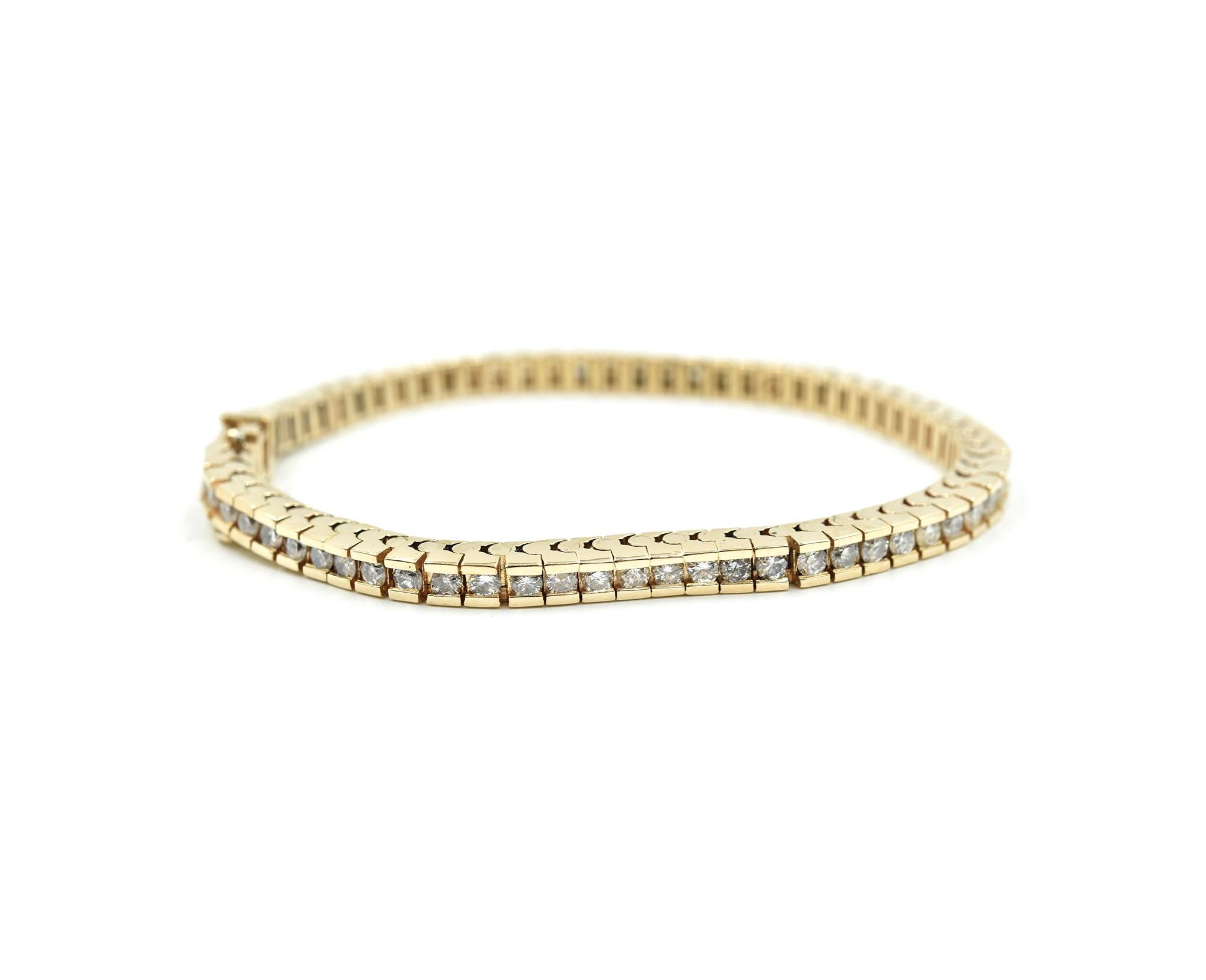 Designer: custom design
Material: 14k yellow gold
Diamonds: 66 round brilliant cuts = 3.96 carat total weight
Color: I
Clarity: SI1
Dimensions: bracelet will fit a 6 3/4-inch wrist
Weight: 20.20 grams

