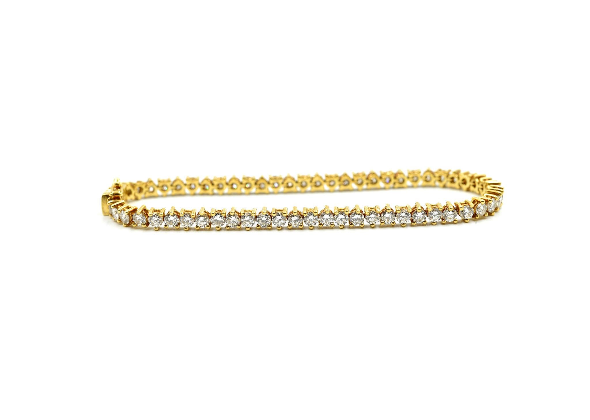 Designer: custom design
Material: 18k yellow gold
Diamonds: 60 round brilliant cuts = 6.60 carat total weight
Color: G
Clarity: VS2
Dimensions: bracelet will fit 6 ¾-inch wrist
Weight: 11.80 grams
