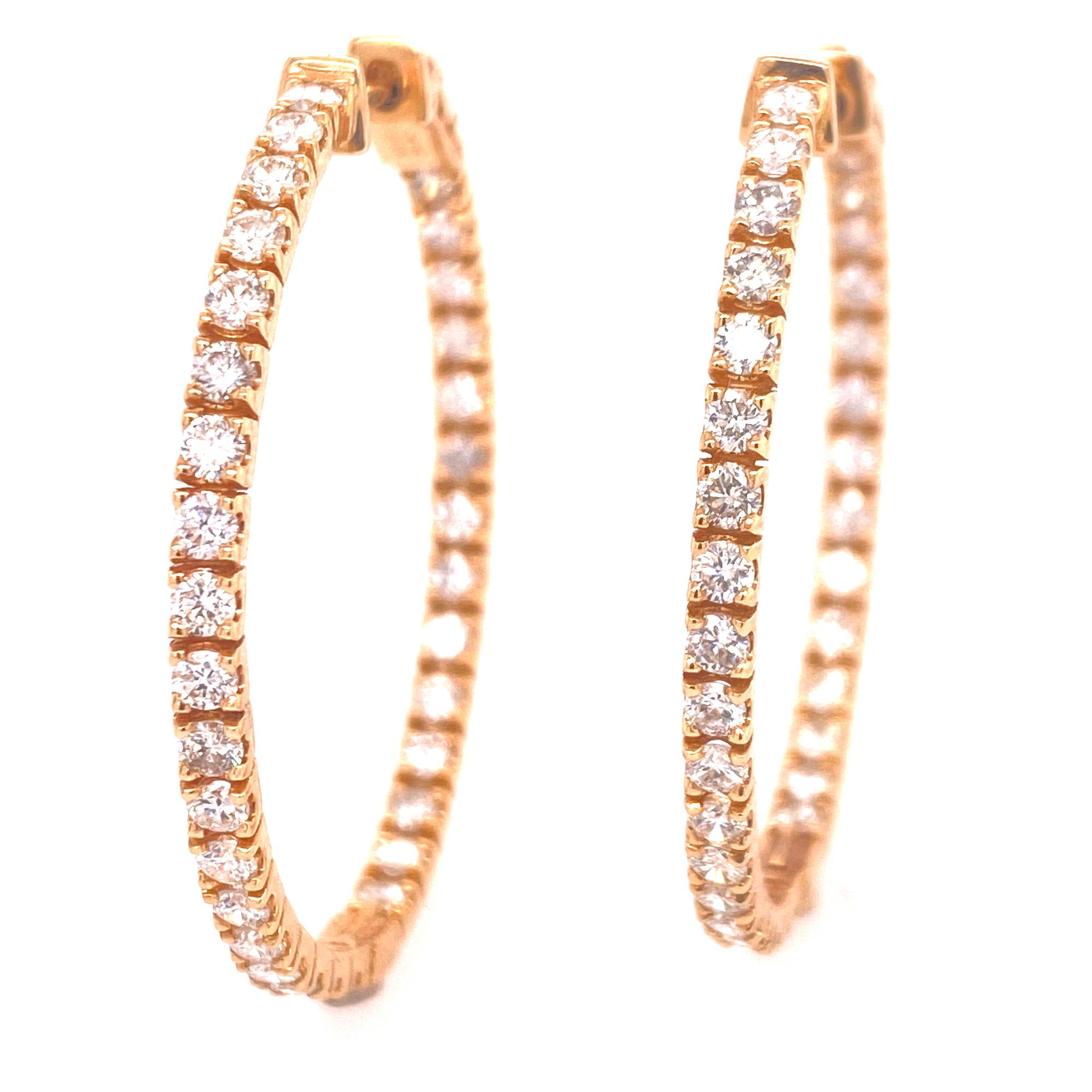 Beautiful diamond in and out hoop earrings crafted in 14 karat yellow gold. The earrings feature round brilliant cut diamonds weighing 2.61 carat total weight and graded G-H color and VS2-SI1 clarity. The hoops measure 1.5 inches in diameter. 