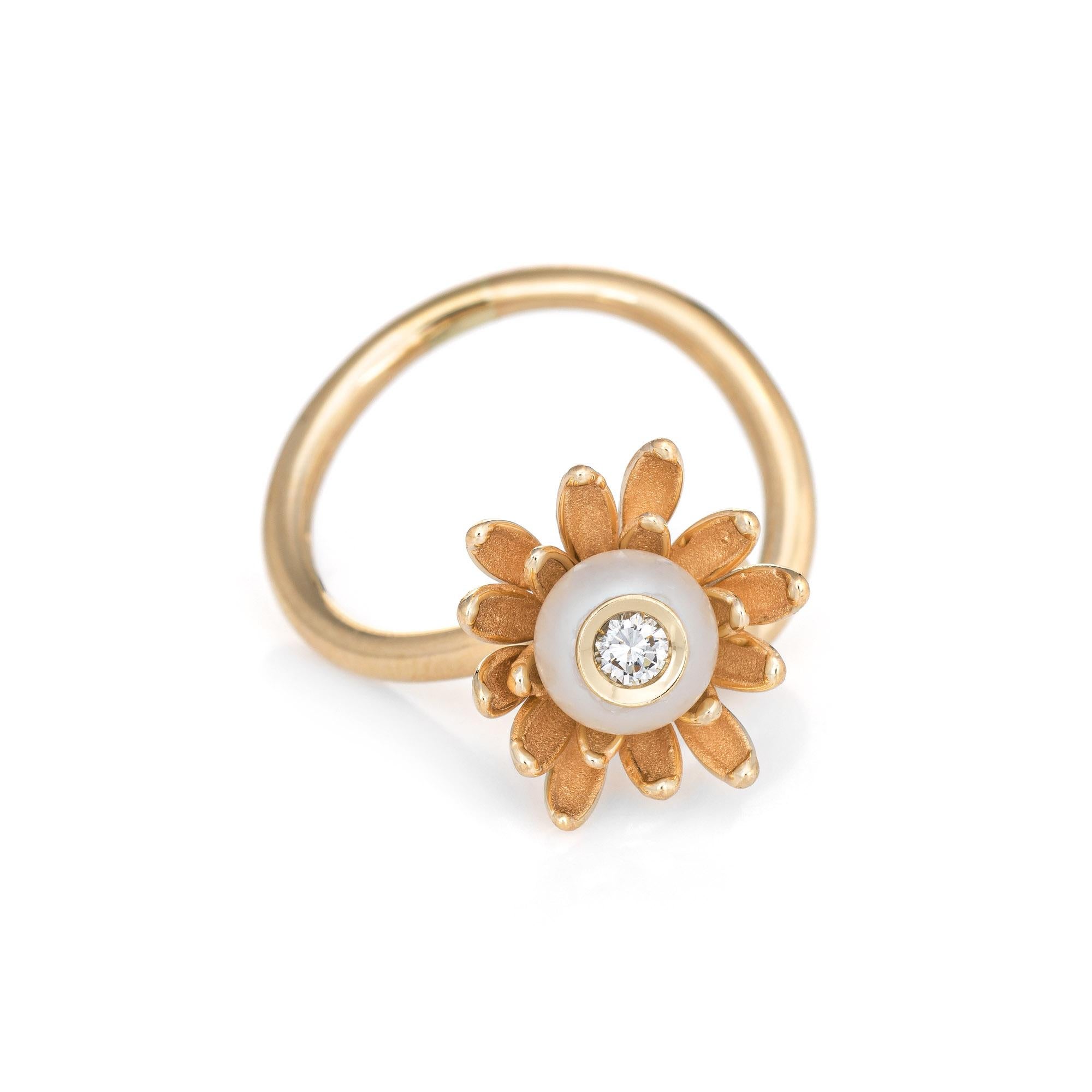 Stylish vintage pearl & diamond flower ring crafted in 14 karat yellow gold. 

7mm cultured pearl is set with an estimated 0.10 carat diamond (estimated at G-H color and VS clarity). The pearl is in excellent condition and free of cracks or chips.