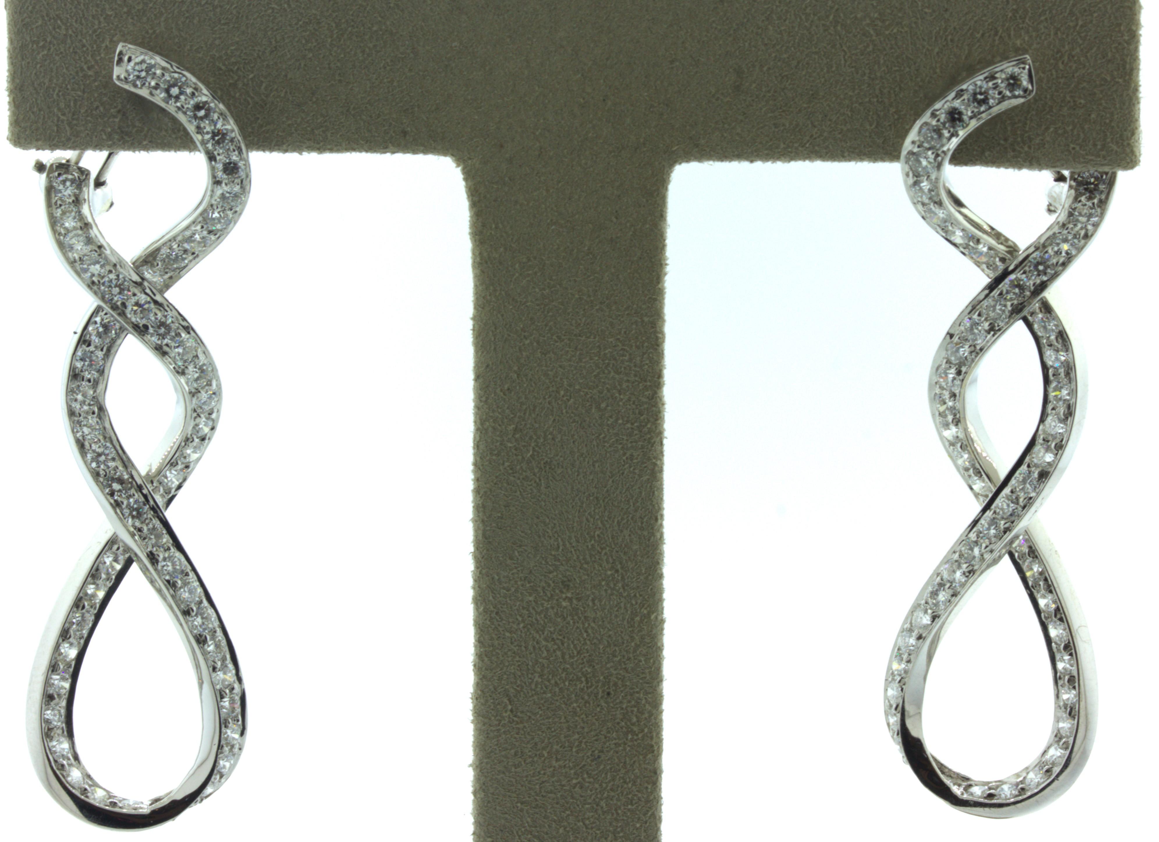 A chic and fine pair of diamond 18k white gold earrings. They feature 3.00 carats of round brilliant-cut diamonds set in spiraling infinites dropping from the earrings. Made in 18k white gold and ready to be worn.

Length: 2 inches

Weight: 10.9