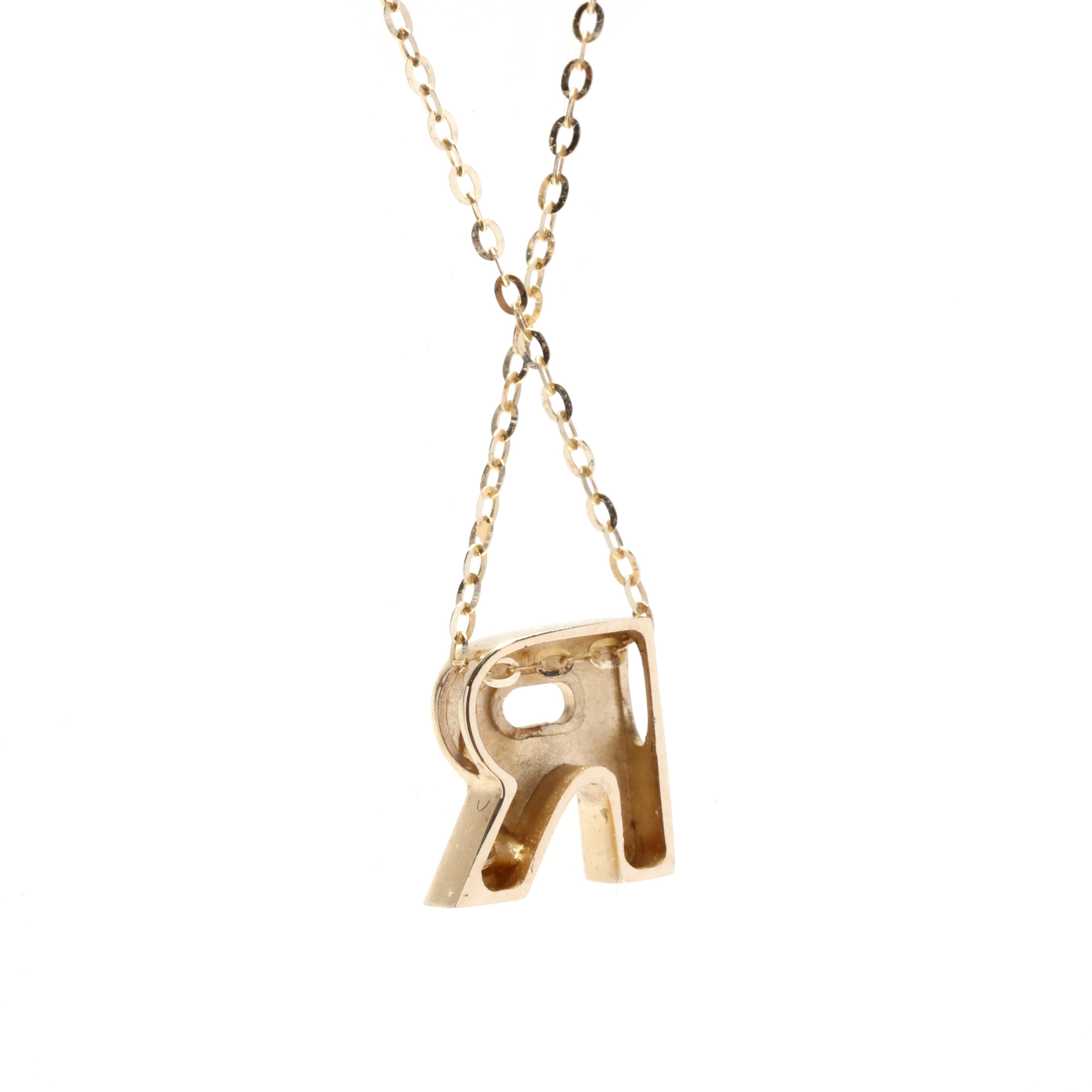 This stunning necklace features a single stone initial pendant in the shape of the letter R. Crafted from 14K yellow gold, the pendant is adorned with a shimmering diamond that adds a touch of sparkle to the piece. The necklace measures 16 inches in
