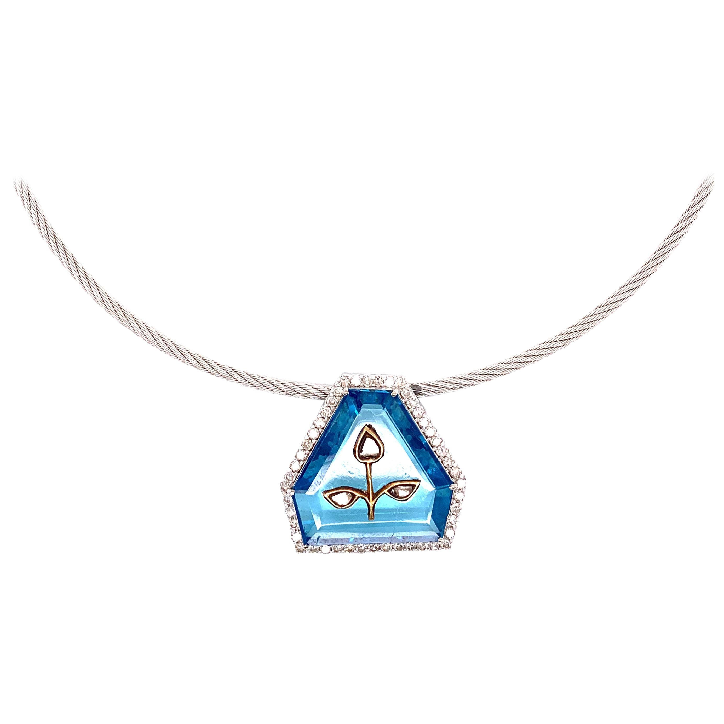 Diamond Inlayed Zircon and White Diamond 18K Gold Pendant with Chain:

A very unique pendant, it features a beautiful shield-cut blue zircon with uncut diamonds inlayed onto the stone, surrounded by a halo of white round brilliant diamonds weighing