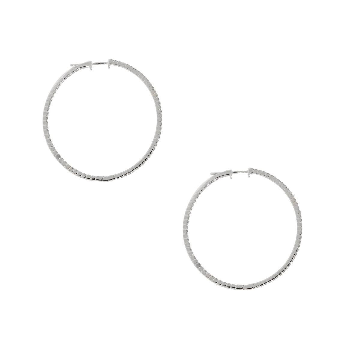 Material: 14k white gold
Style: Diamond inside out hoop earrings
Diamond Details: Approximately 1.04ctw of round brilliant diamonds. Diamonds are G/H in color and S1 in clarity
Earring Measurements: 1.56″ x 0.05″ x 1.56″
Total Weight: 5.2g