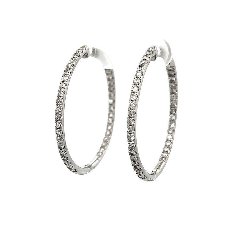 These earrings feature an endless inside-out round hoop design, for sparkle from every angle. These earrings are made with white round diamonds with a total weight of 1.50CT and are set in polished 14K white gold. 
