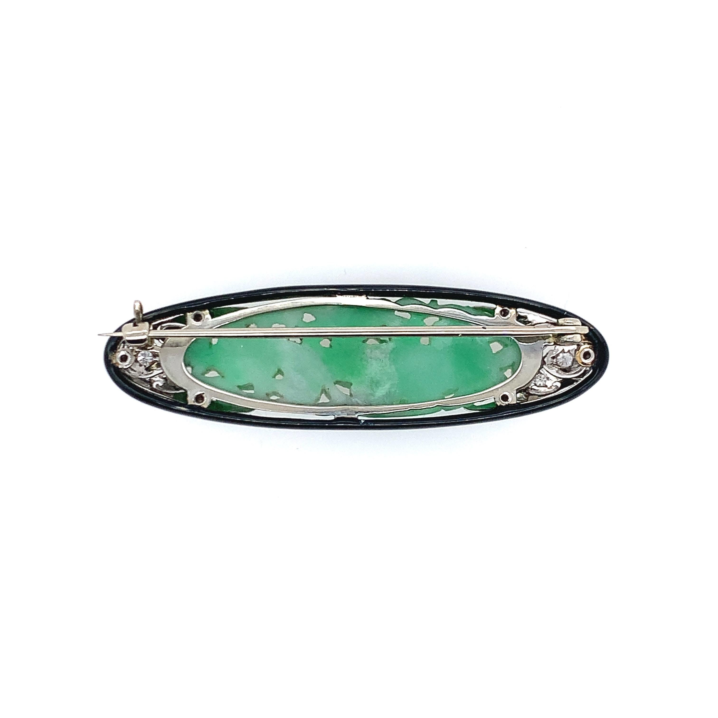 With a nice black enamel trim, this art deco brooch is set in platinum and consists of 0.20 carat diamonds as well as natural, type A jade at the center. The length is 0.63 inch and the width is 2.13 inches. The total weight is 10.2 grams.