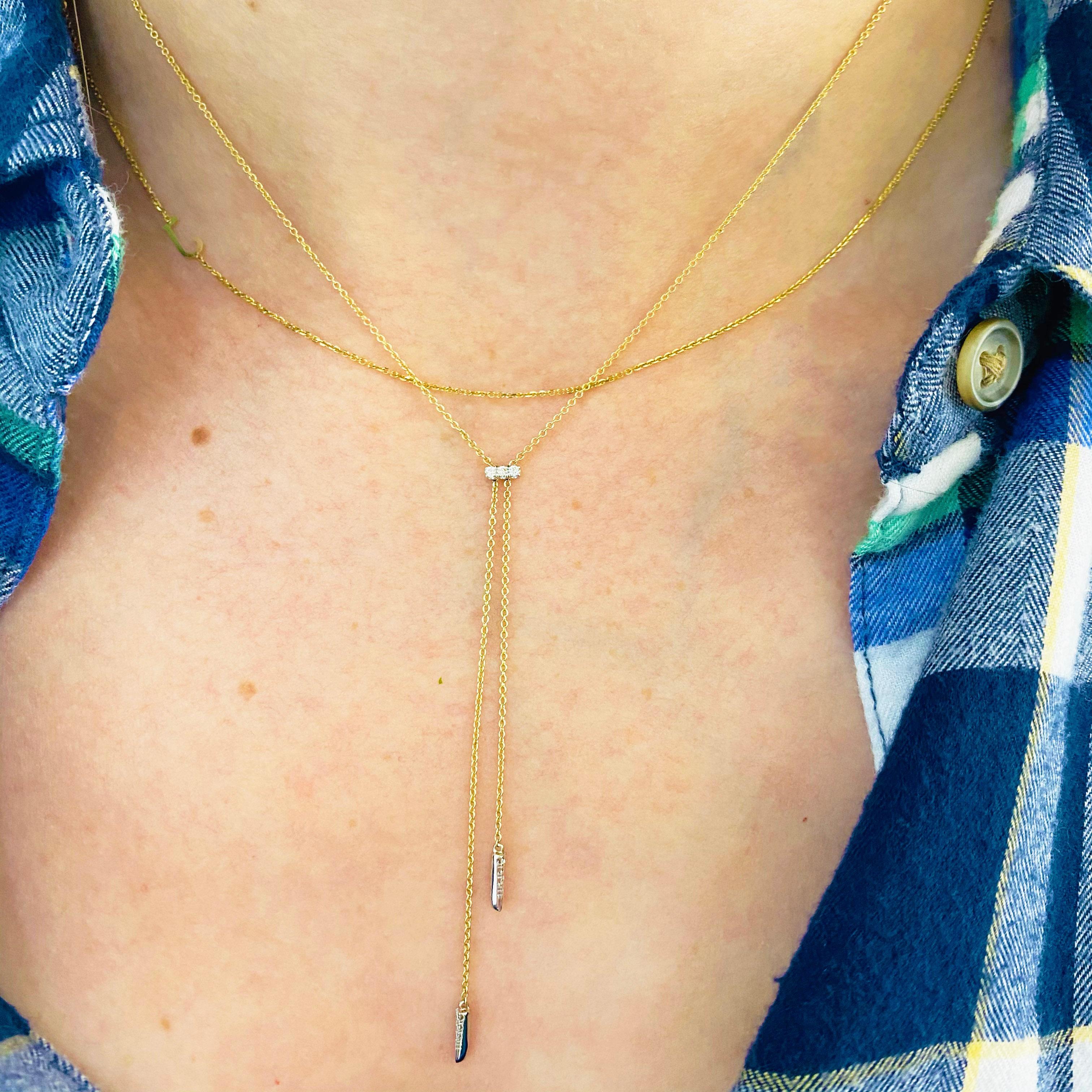 This stunningly beautiful 14k yellow and white gold adjustable lariat necklace dripping with diamonds provides a look that is very modern yet classic! This necklace is very fashionable and can add a touch of style to any outfit, yet it is also
