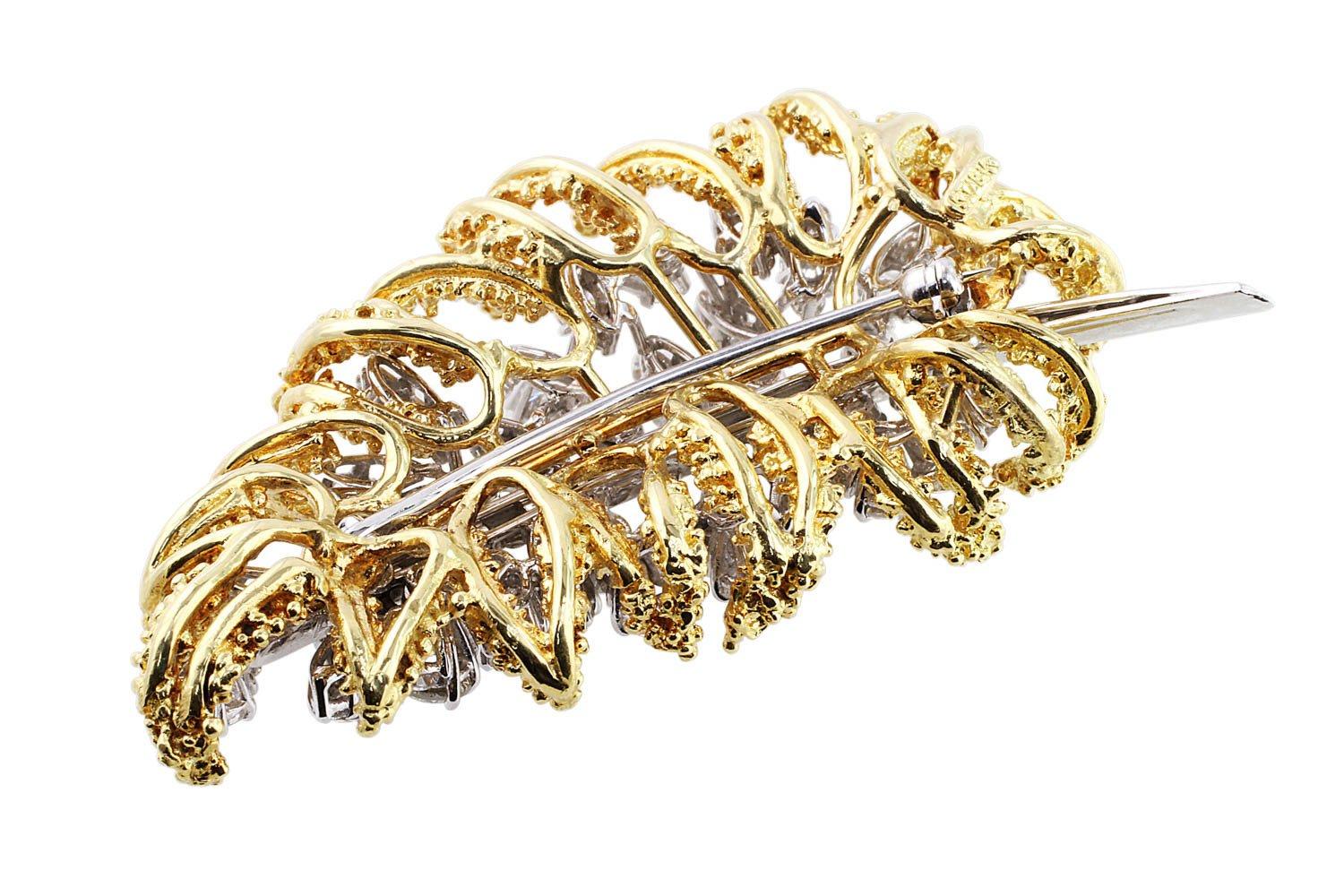 Diamond Leaf Brooch. Estate platinum and 18k yellow gold brooch with 81 brilliant cut diamonds and 18 tapered baguette-cut natural diamonds in the platinum setting. The 81 round brilliant cut diamonds are made up of 48 diamonds of 0.05cts each, 24