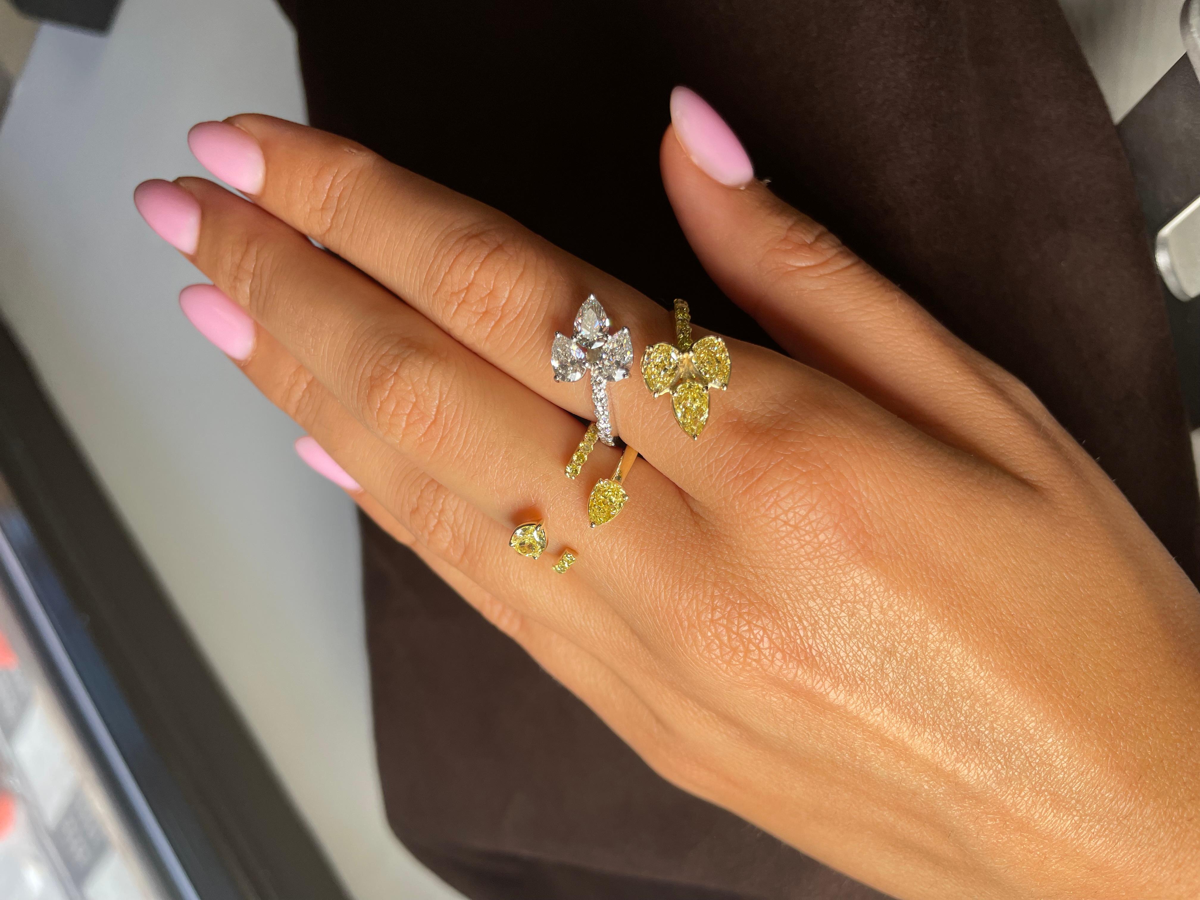 Featuring a unique Diamond Leaf Bypass Ring.  showcasing a one-of-a-kind design. Adorned with 3 pear-shaped Yellow Diamonds, totaling 1.26 carats, and 3 pear-shaped Colorless Diamonds, totaling 1.20 carats, this ring is a true marvel. The