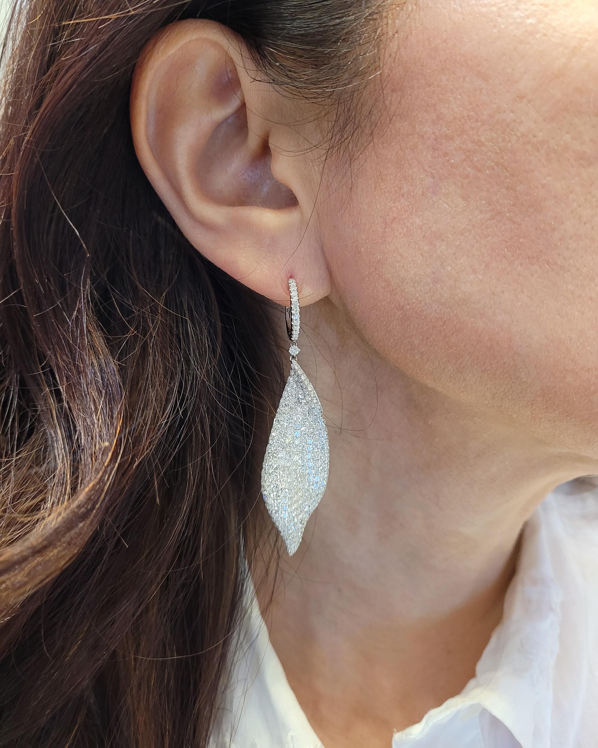 The splendid sparkling surface defines the sculptural shape of these distinctive Diamond Leaf Earrings. Crafted in 18K white gold, the mirror image pair is embellished with round brilliant-cut diamonds all over in a pavé setting, weighing a total of