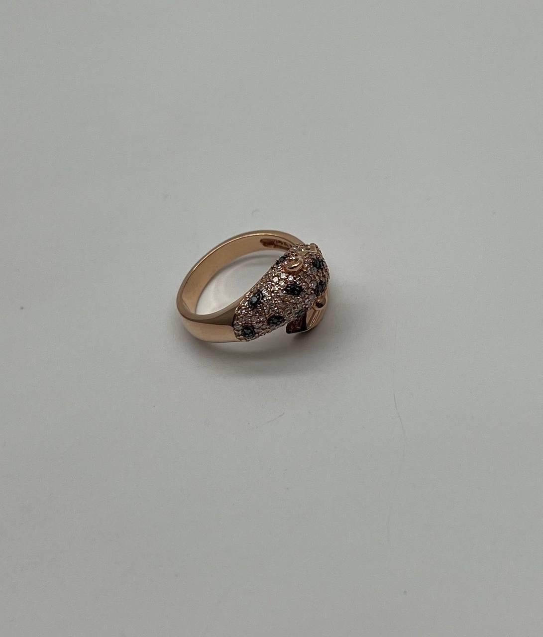 A sophisticated and elegant ring featuring a unique wrap-around design of panther leopard. The ring is adorned with sparkling diamonds, including black accents, creating a striking contrast and intricate pattern. Crafted with precision, this