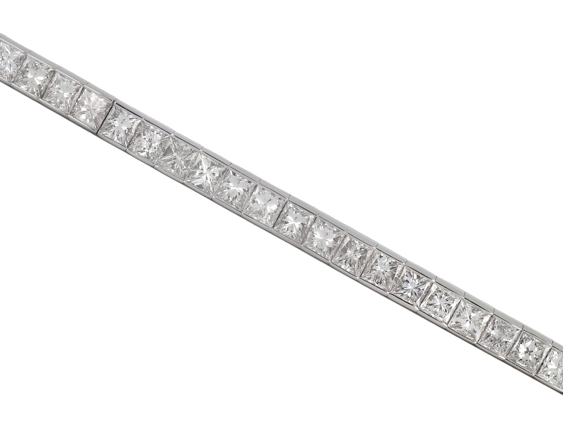 Diamond line bracelet. Set with forty four square radiant cut diamonds in open back rubover settings with a combined approximate weight of 17.60 carats, to a striking articulated line bracelet, flowing with movement, featuring polished edges, an