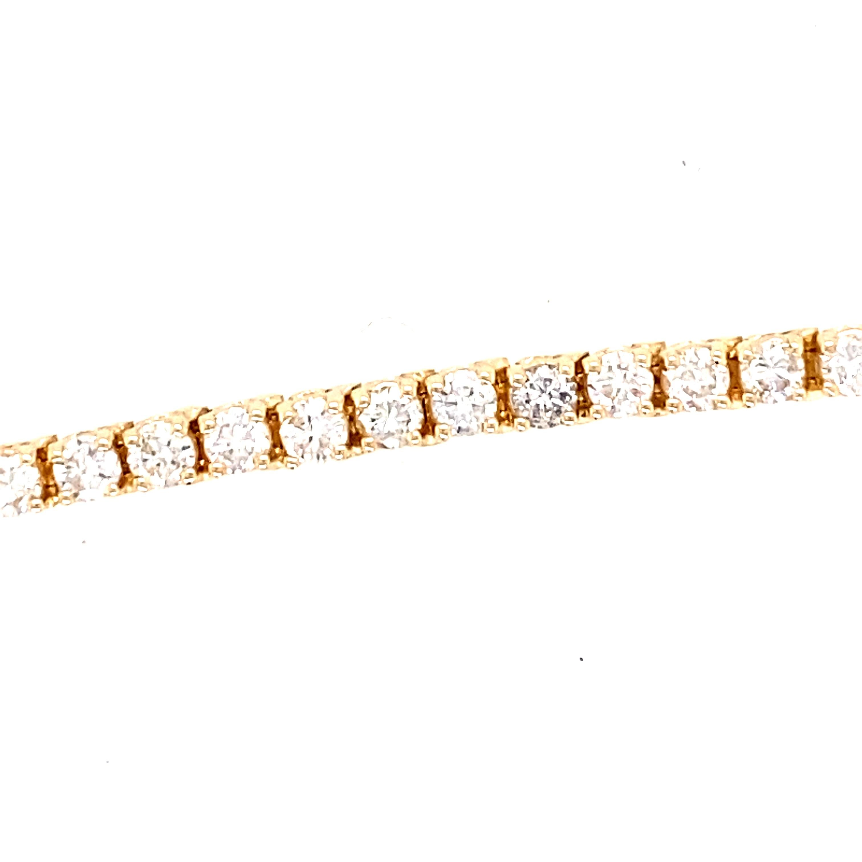 One estate 14 karat yellow gold (stamped 14K) line bracelet set with fifty-one round brilliant diamonds, 5.00 carats total weight with matching J/K color and SI1/SI2 clarity. The bracelet measures 7 inches in length and weighs 12.5 grams and is