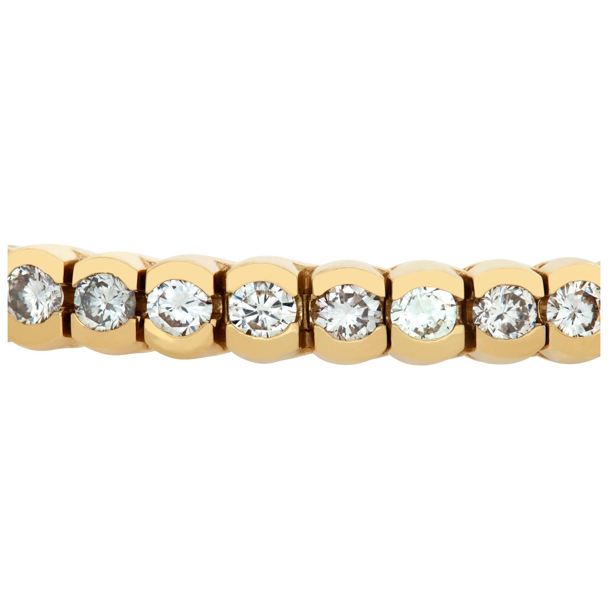 Elegant diamond line bracelet in 14k yellow gold with over 7 carats in round diamonds (J-K color, SI clarity), 7 inch length, 5mm width.
