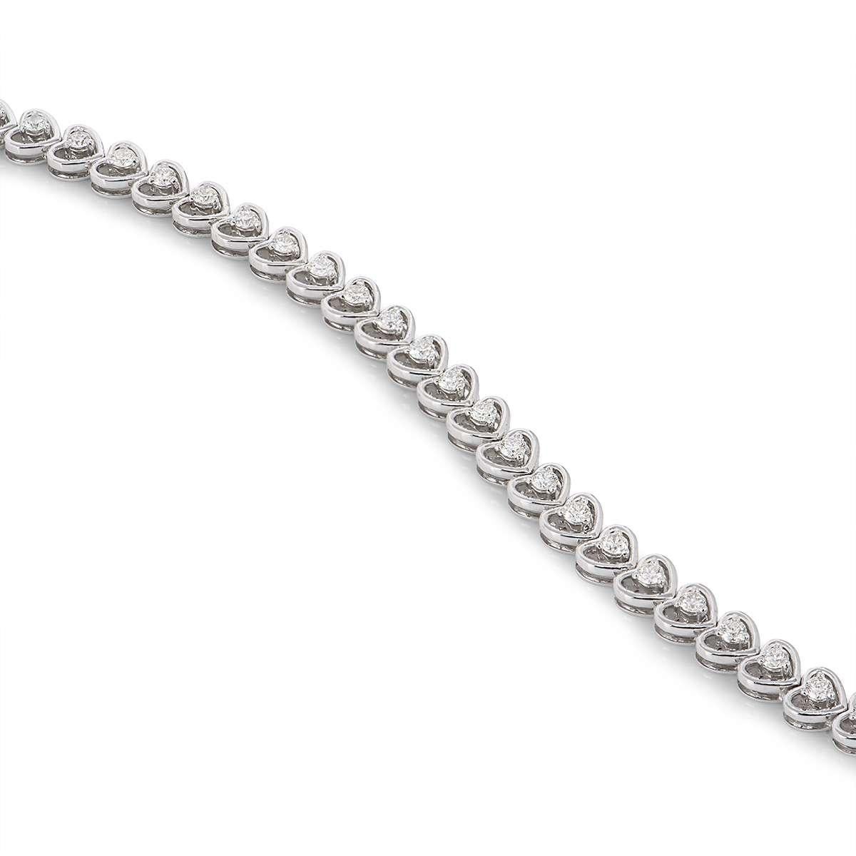 A beautiful 18k white gold diamond line bracelet. The bracelet comprises of 35 cut out hearts with round brilliant cut diamonds set in the centre of each. The diamonds come to a total weight of 1.97ct, G-H colour VS clarity. The bracelet features a