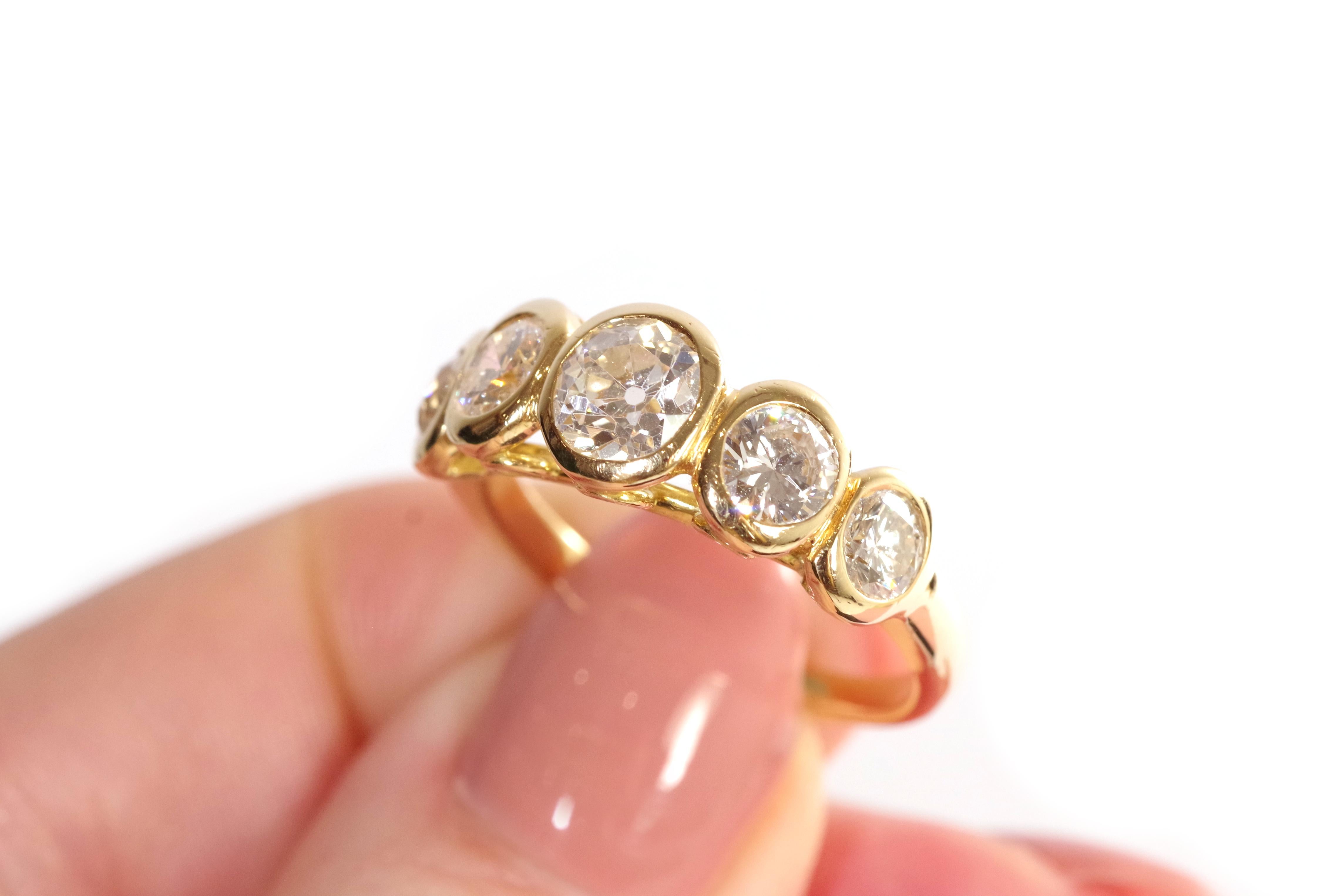 Diamond line ring in 18k yellow gold. Adorned with five diamonds, the central one being more significant (0.95 ct), they are in old mine cut and brilliant cut (two old mine cut diamonds, three brilliant-cut diamonds). The basket of the ring, under