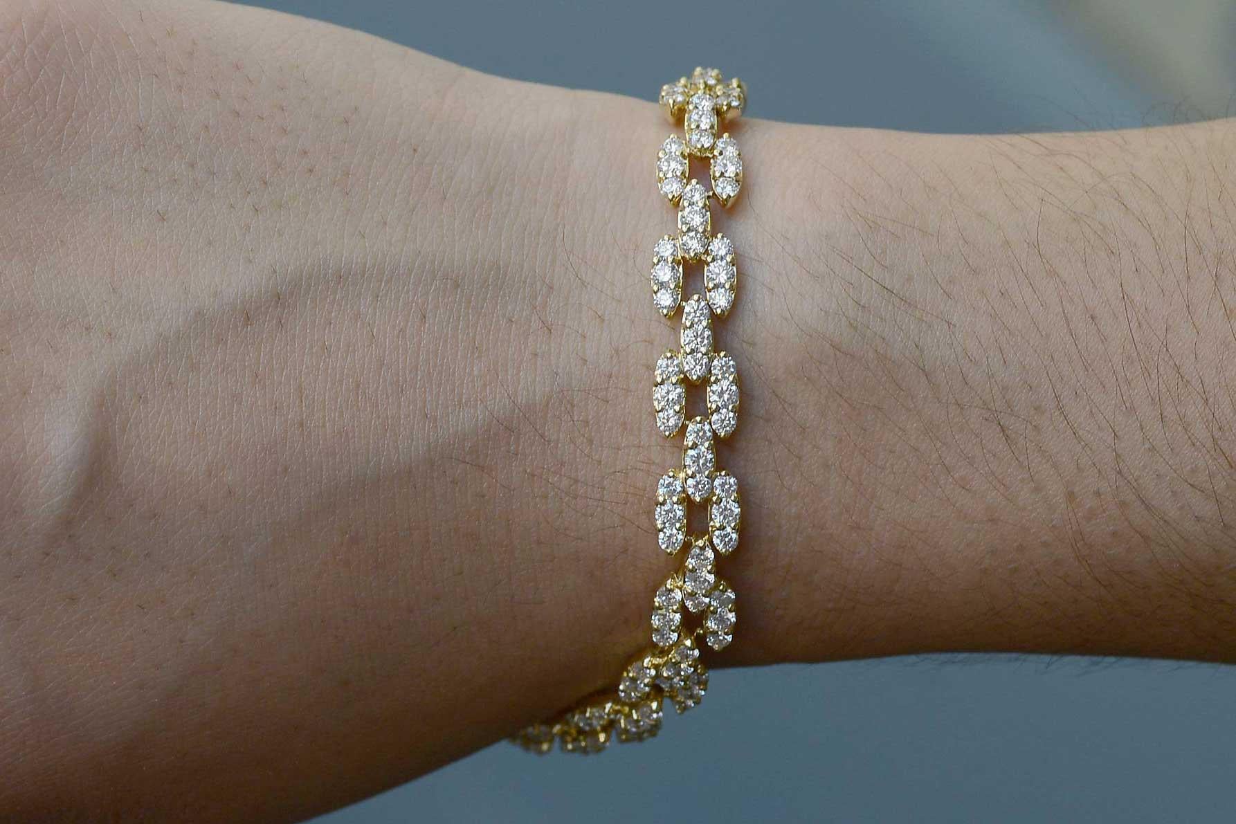 The Philadelphia Modernist Bracelet. An exquisite 1970s 18K yellow gold diamond link bracelet adorned with over 7 carats of extremely attractive and fiery diamonds. 162 individually cut and perfectly matched gems set in an articulating pattern that