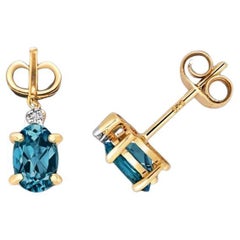 DIAMANT & LONDON BLUE TOPAZ OVAL CLAW SET STUDS IN 9CT Gold