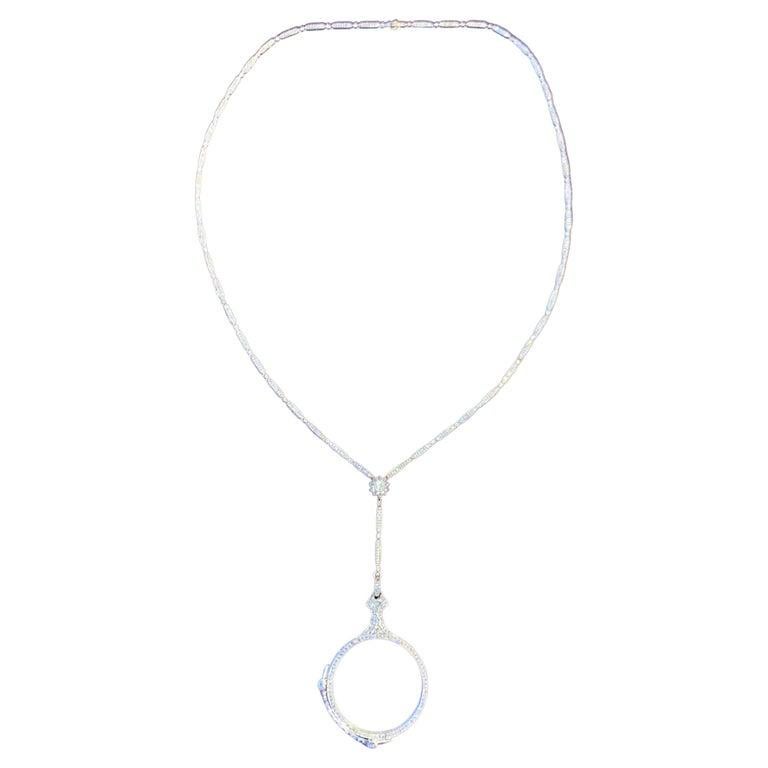 Diamond Lorgnette Necklace

An 18 karat white gold necklace set throughout with diamonds and a cabochon moonstone, featuring foldable lorgnette opera glasses

Neck Length: 25
