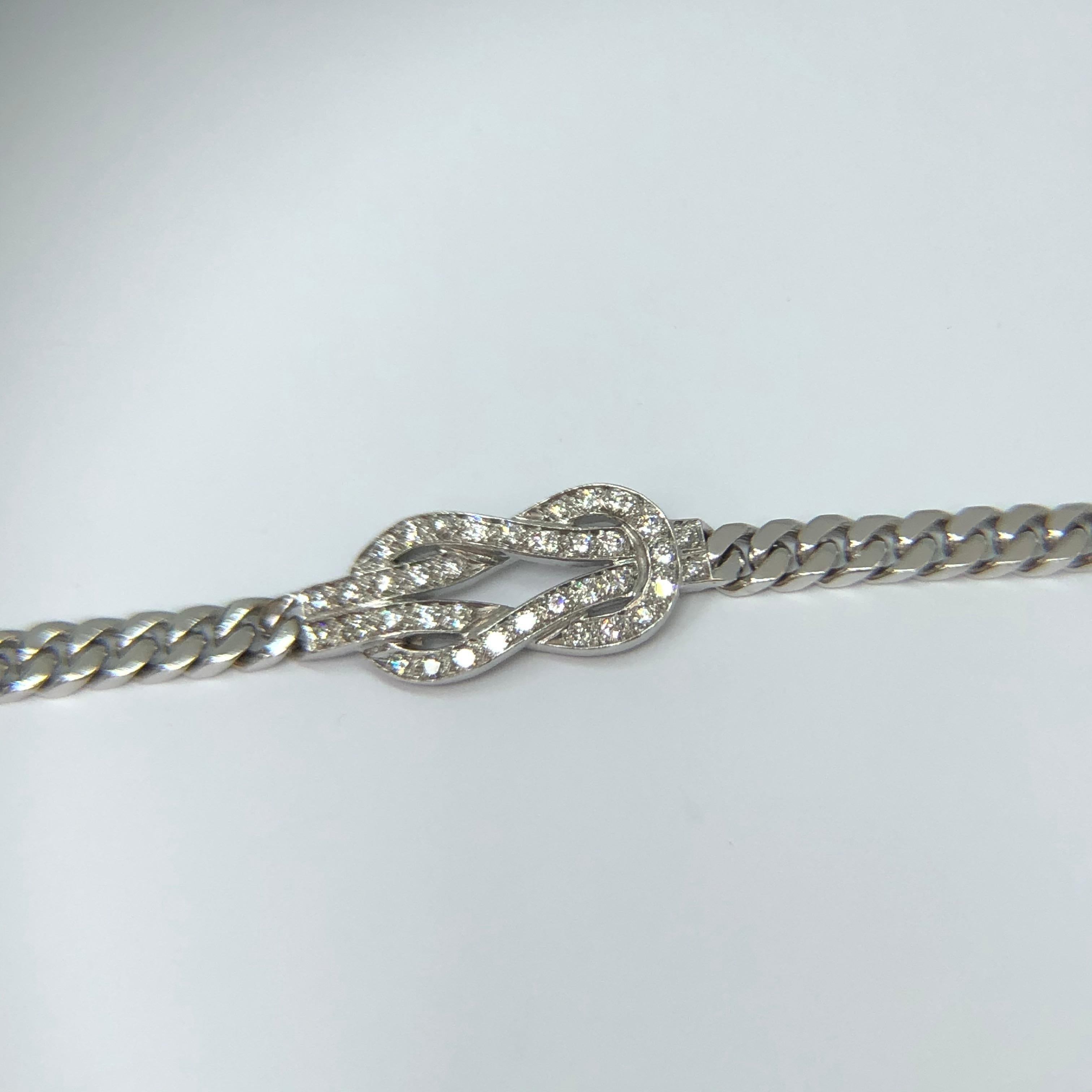 18k white gold bracelet with .75ct brilliant -cut diamond knot. The curb link chain measures 18.7cms but can be reduced in length. Weight 26.7gms 
The Herculean love knot signifies a tie that when stretched simply strengthens and cannot be broken.