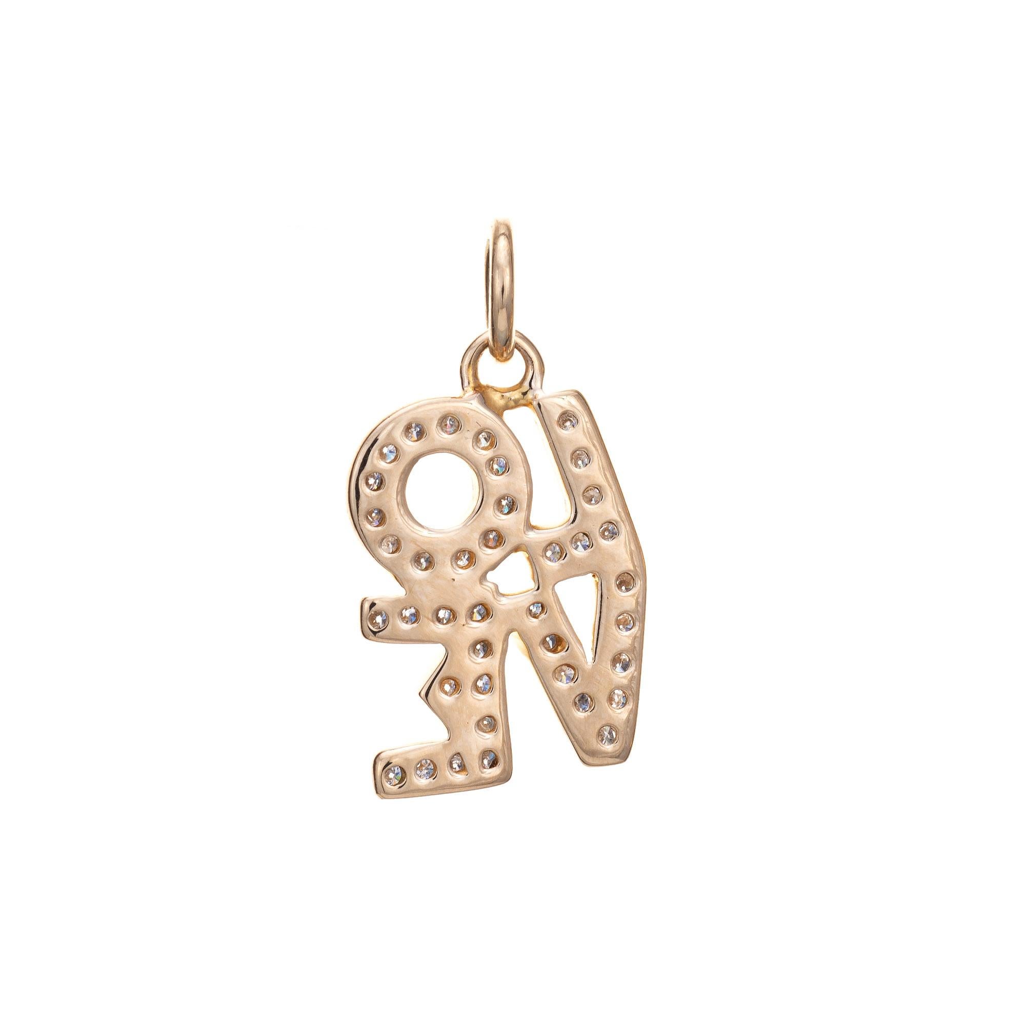 Stylish vintage diamond LOVE pendant crafted in 14k yellow gold (circa 1970s). 

Diamonds total an estimated 0.25 carats (estimated at H-I color and SI1-I1 clarity).

Smaller in scale in a block letter design, the love pendant can be worn as a charm