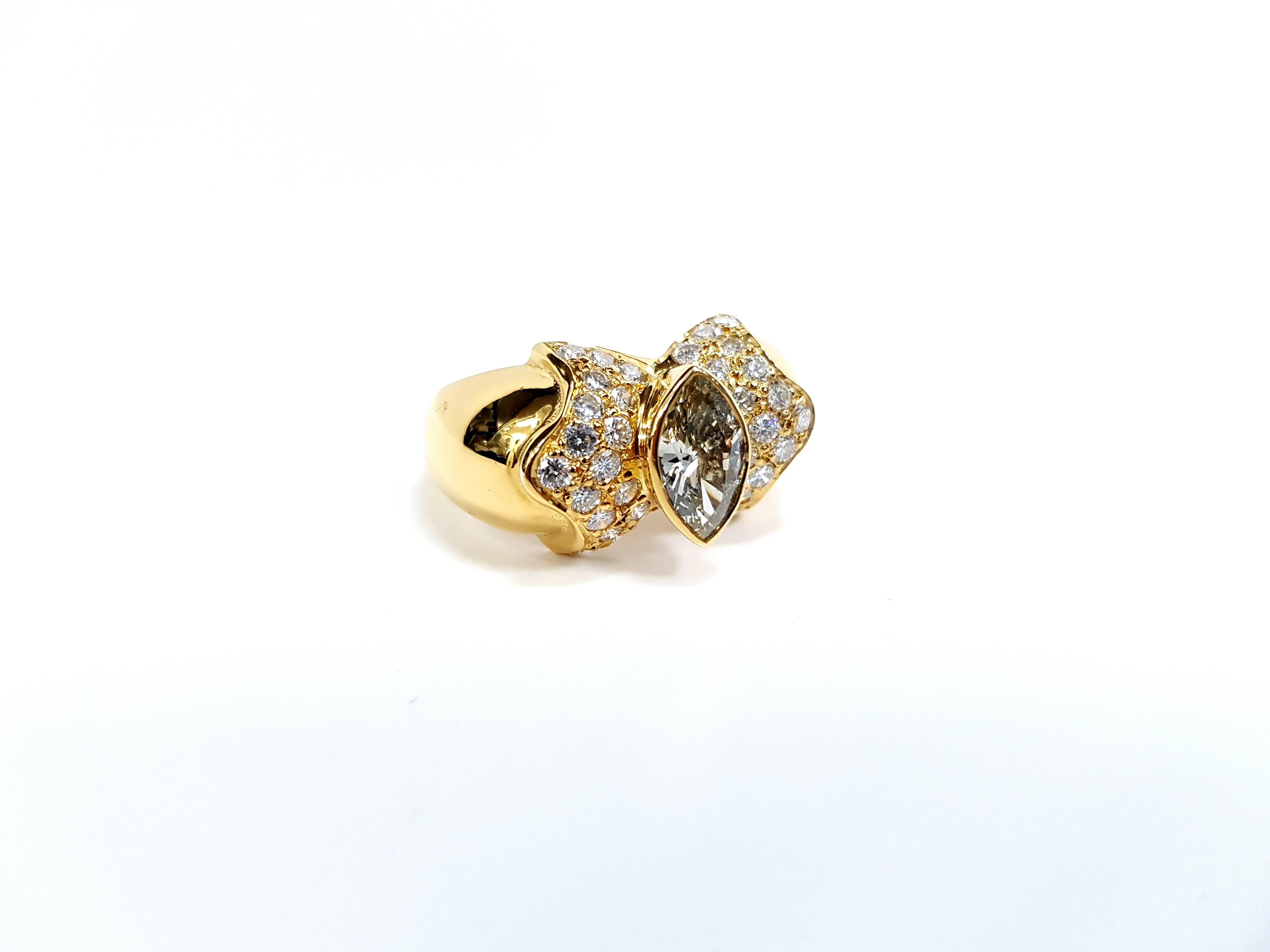 Vintage Diamond Marquise Round Brilliant Cut Cocktail Ring Yellow Gold.
Unique diamond bow tie style ring, with round brilliant cut diamonds set in 18k yellow gold. The main stone is a marquise shaped diamond weighing approximately 0.95 - 1.10