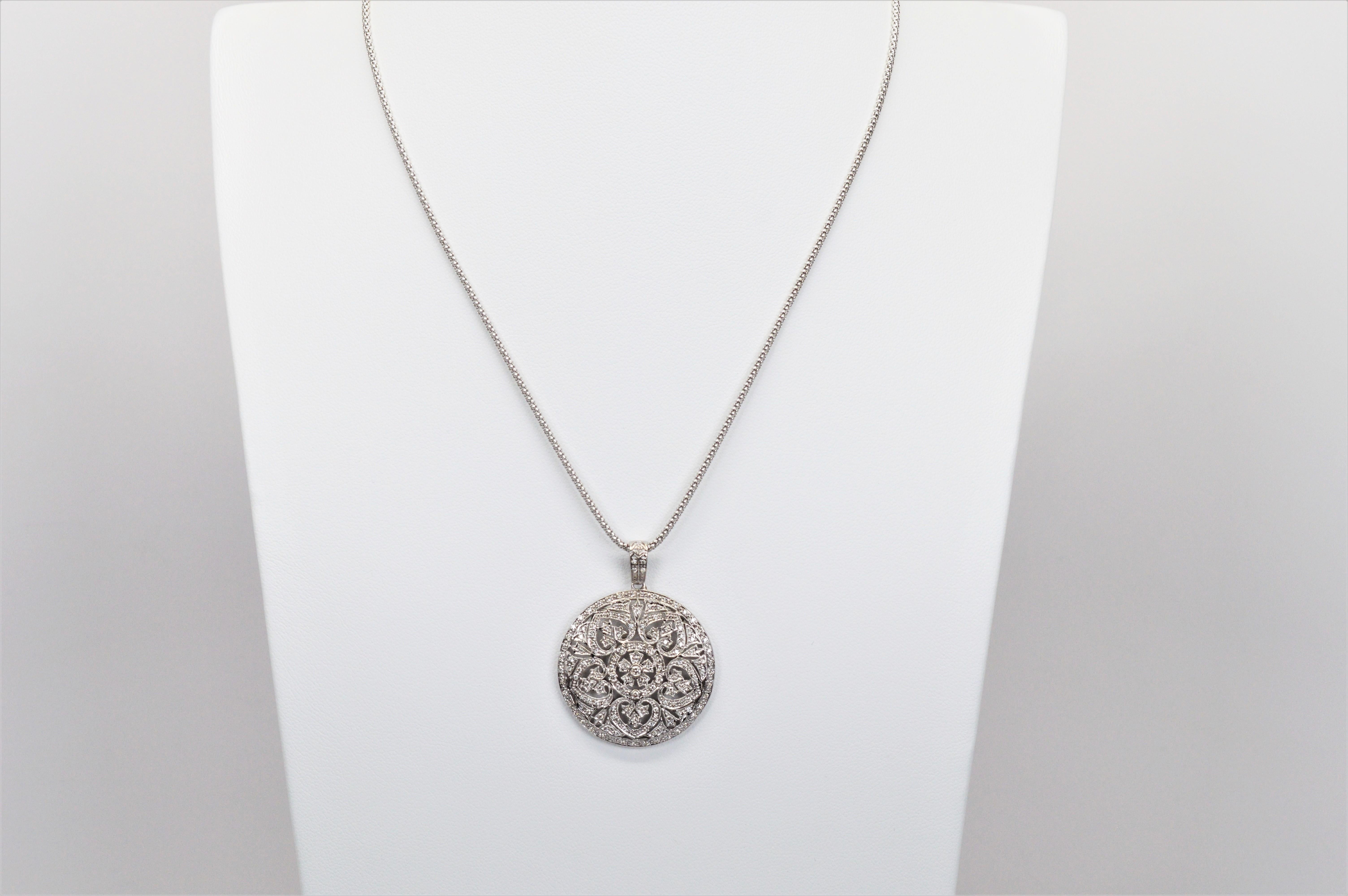 With plenty of shimmer, this exquisite diamond covered 1-1/8 inch round medallion pendant in fourteen karat 14K white gold is suspended on a 16 inch glistening 1.75mm 14 karat white gold popcorn chain. 
Quality Italian made, the intricate pendant is