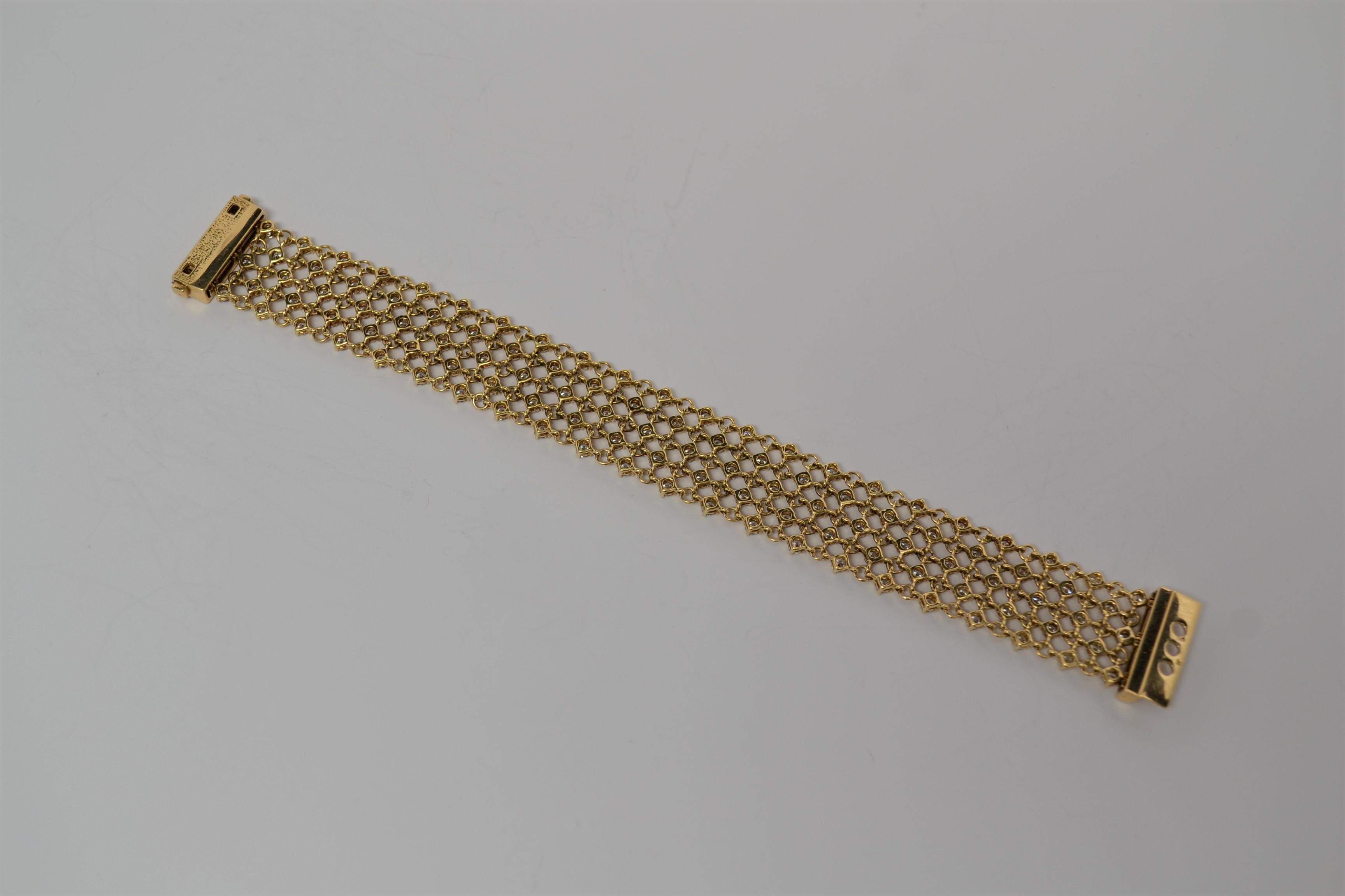 A finely made 18K Yellow Gold and Round Brilliant Cut Diamond Bracelet. The bracelet is a five row layout in a mesh format with round 18K Yellow Gold links and four prong Diamond baskets. Diamonds are also set in the proprietary open and closure