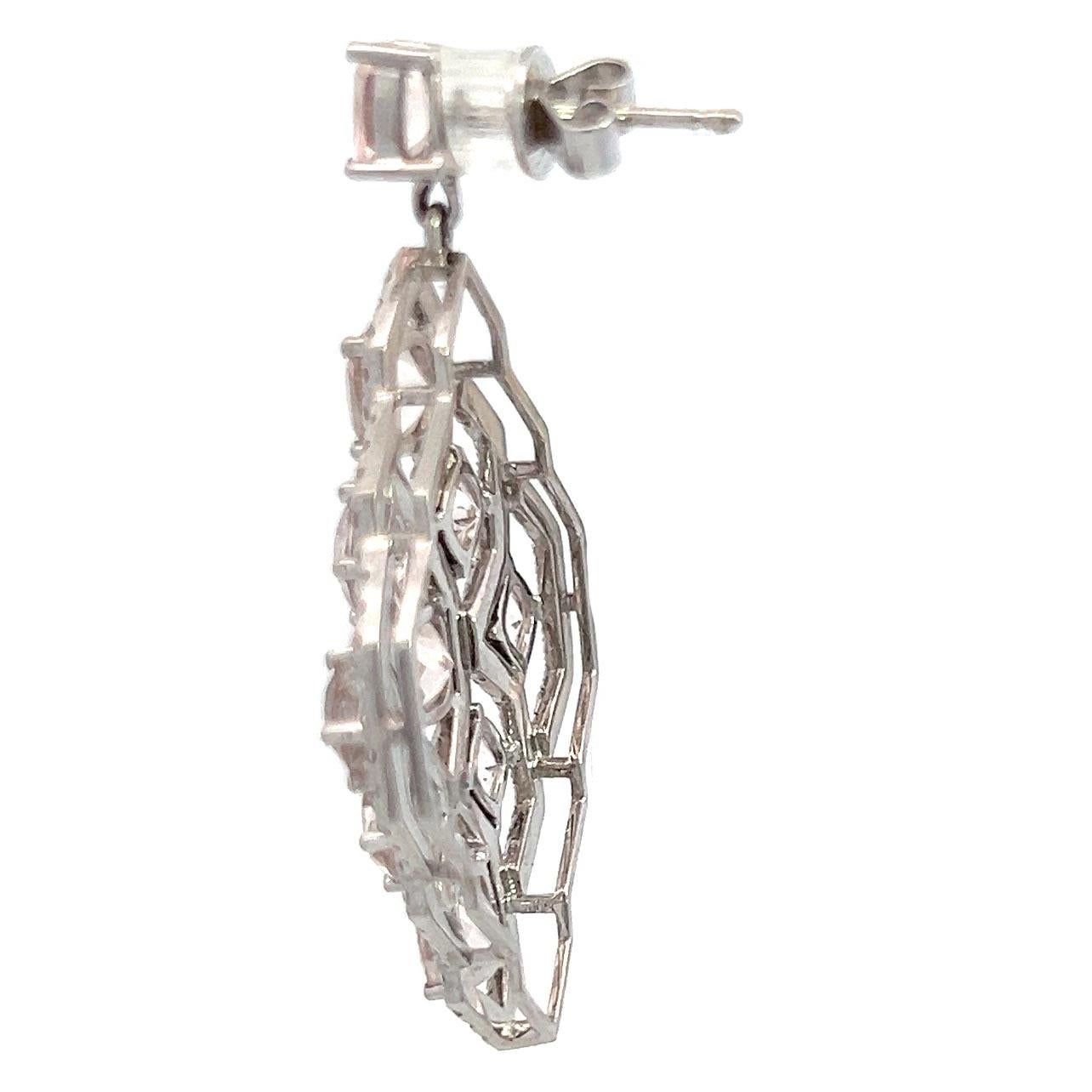 These exquisite earrings feature a stunning combination of diamonds and morganite, which are designed in an intricate lattice. Crafted in 18 karat white gold these morganite and diamonddangle earrings are a perfect staple ad addition to your jewelry