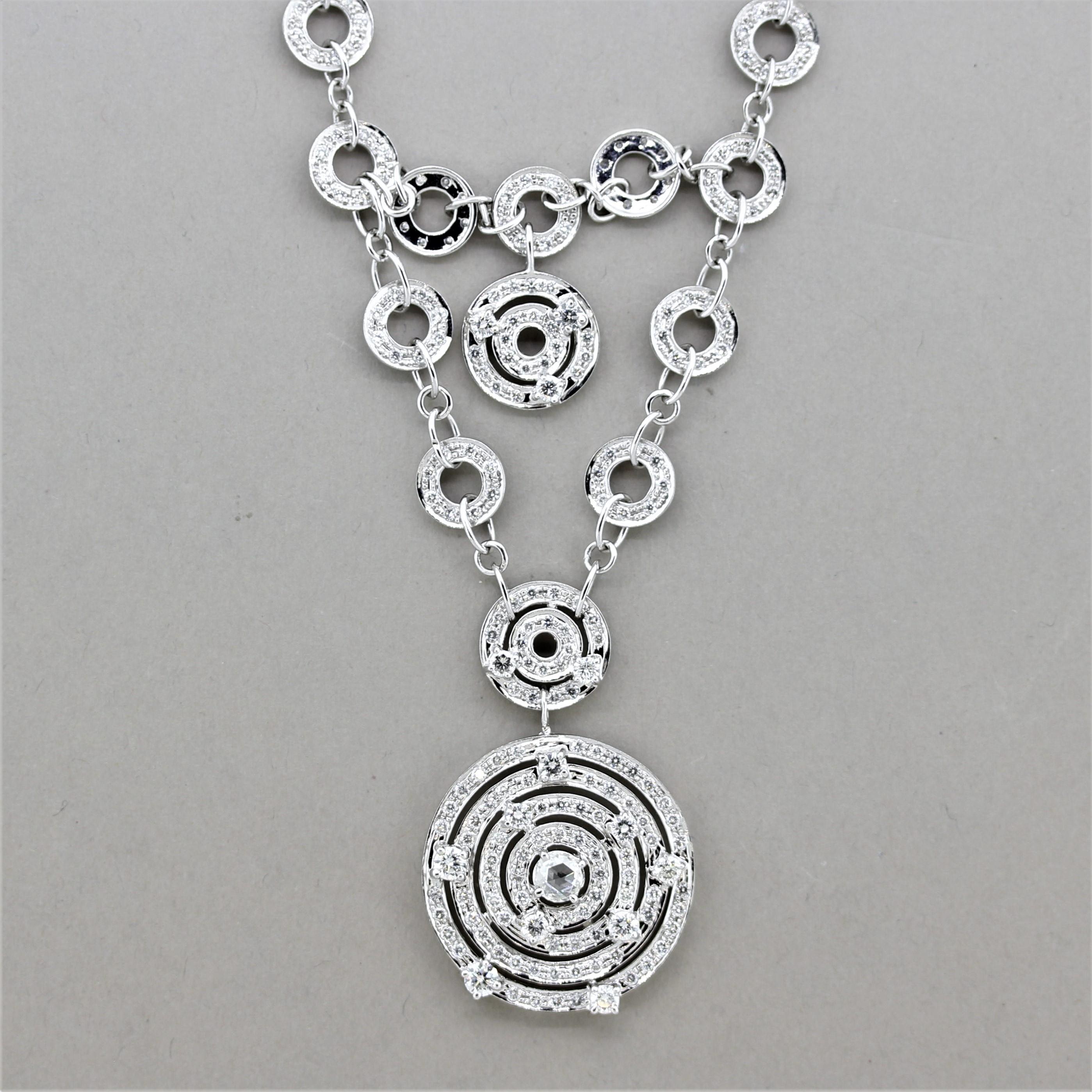 A unique and stylish necklace featuring 3.76 carats of round brilliant-cut diamonds along with one larger rose-cut diamond. They are set around the various circles giving the piece a fun open style. Made in 18k white gold and ready to be