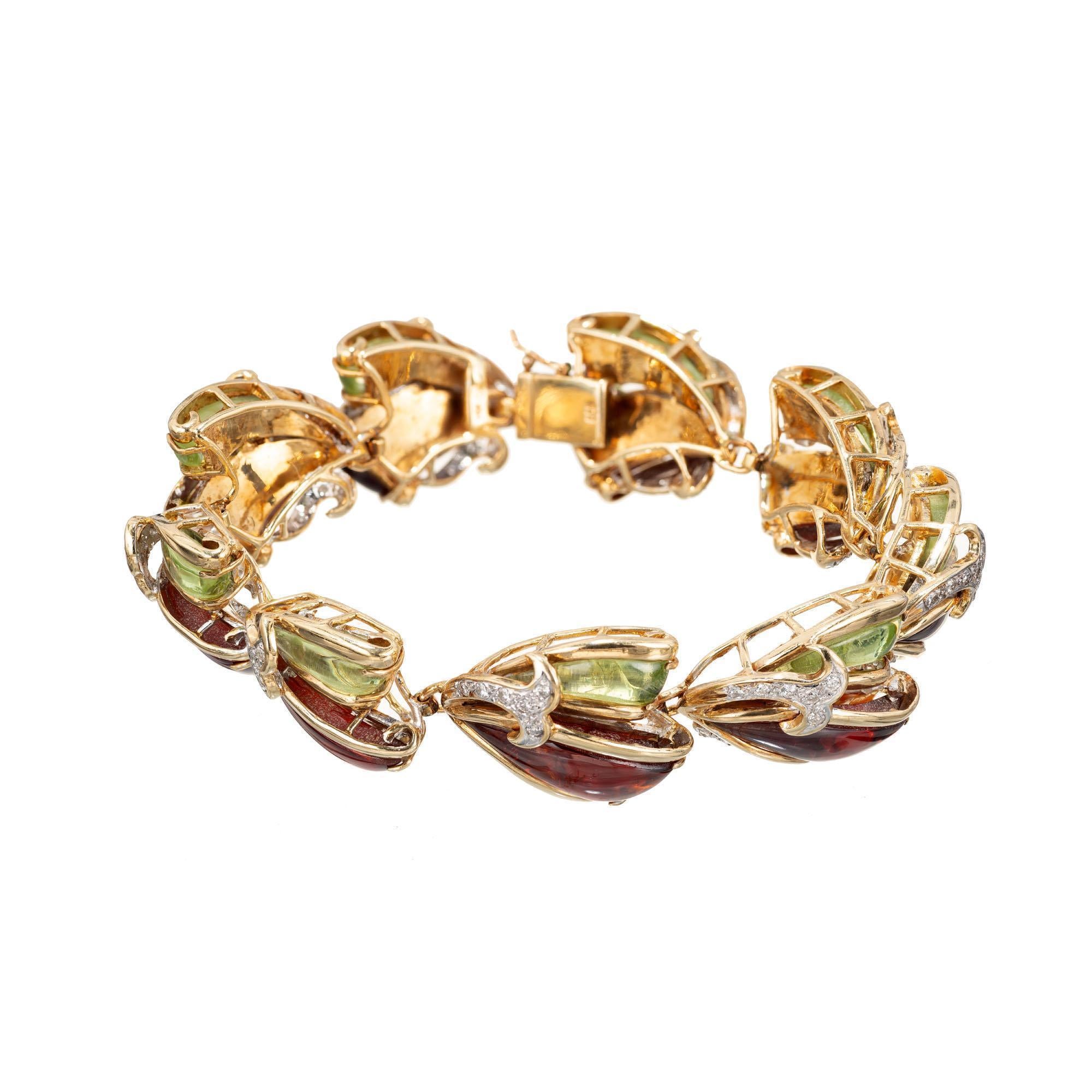 Reddish brown and green glass inlay, diamond and enamel yellow and white gold bracelet. Pave set full cut diamonds. The enamel is thick and translucent, 3mm plus. 

54 round diamonds total weight .75cts. 
Red and green enamel. 
7.75 inches.
Stamped