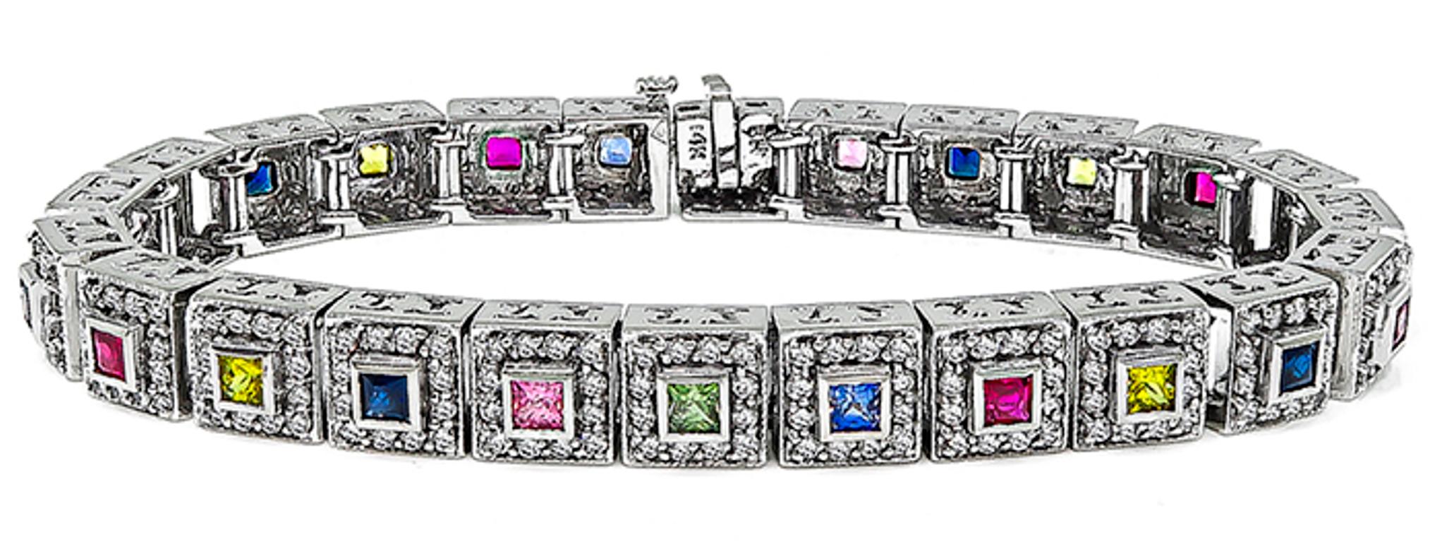 This amazing 14k white gold bracelet is set with sparkling round cut diamonds that weigh approximately 4.00ct. graded H color with VS clarity. The diamonds are accentuated by lovely princess cut multi-colored sapphires and rubies that weigh 1.60ct