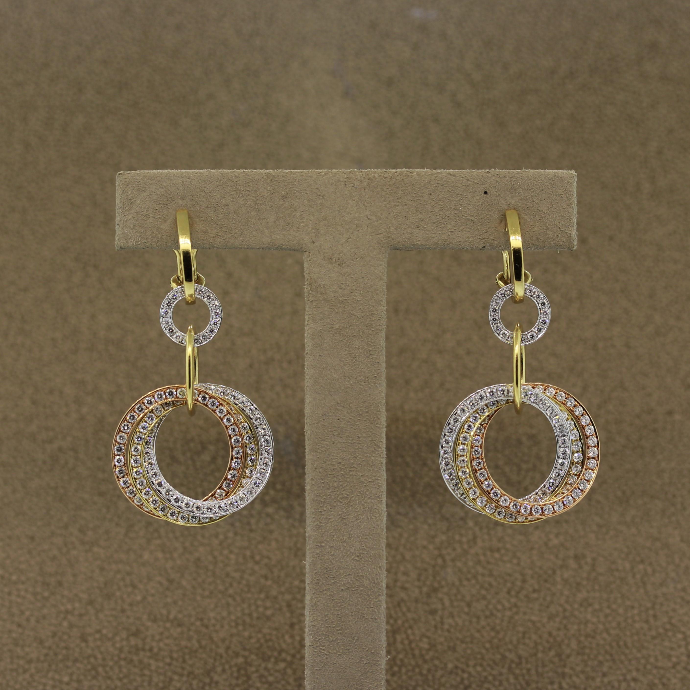 A special pair of earrings, in fact one of our favorites as well! They feature 3 independent hoops each made with a different color of 18k gold! Rose, Yellow and White. They overlap with each other and move freely from one another. They are set with