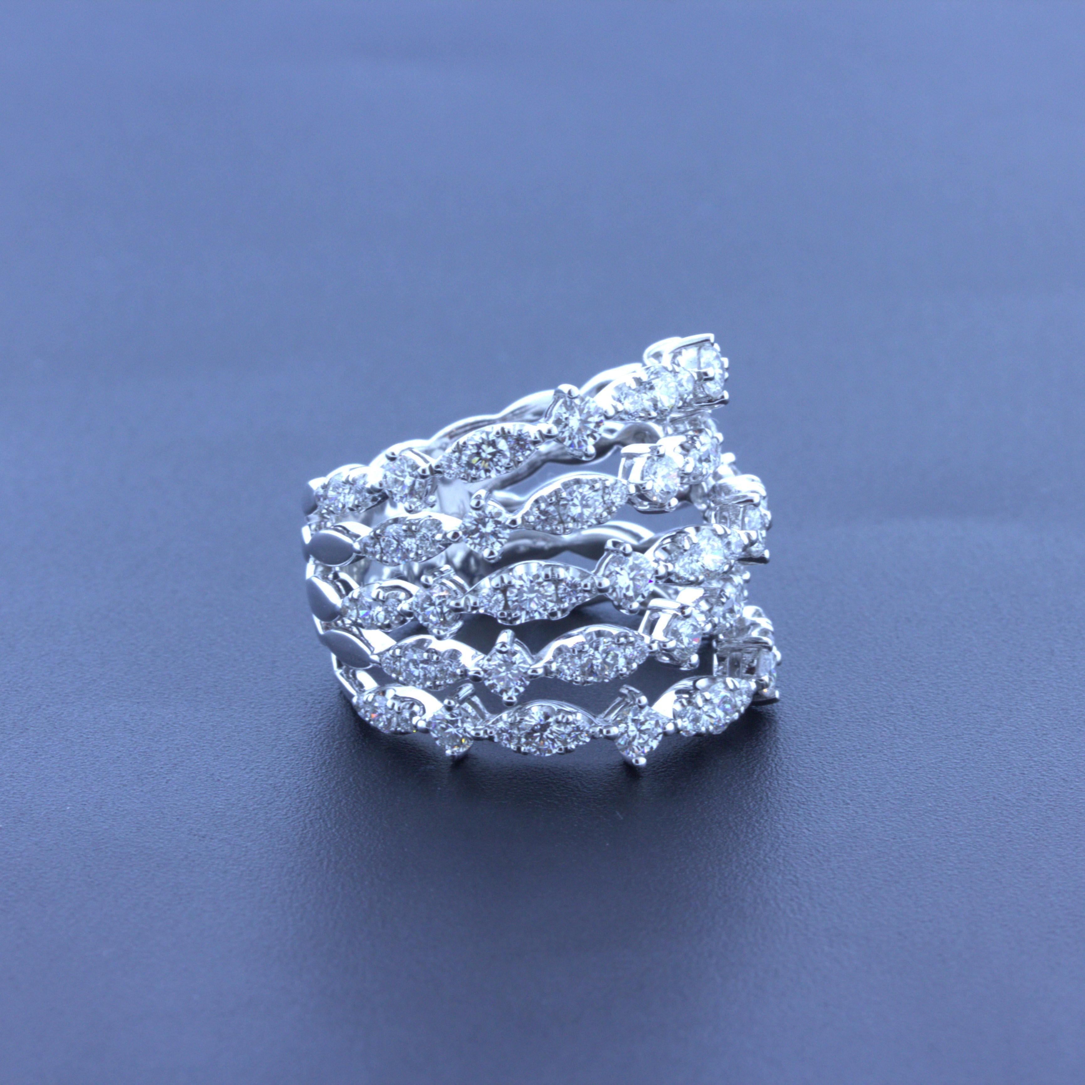 A modern and stylish diamond ring made in 18k white gold. It features 2.83 carats of round brilliant-cut diamonds set across 5 rows which wrap around the finger. The diamond setting alternates from 1 larger single diamond to 3 diamonds set by each