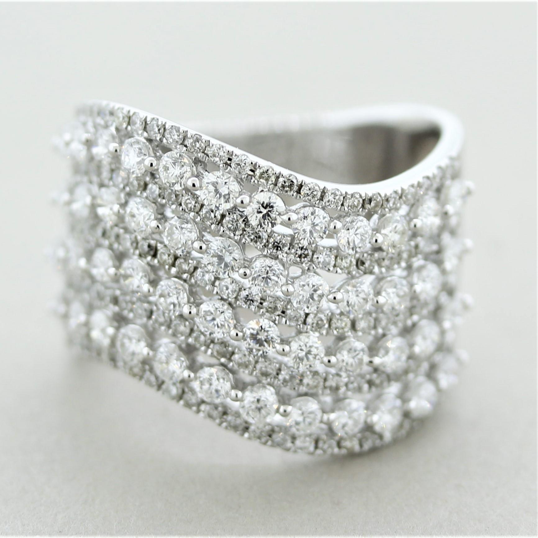 A stylish ring featuring rows of diamond waves over white gold. There are 2.43 carats of fine round brilliant-cut diamonds set in a stylish pattern alternating between larger and smaller sizes. Made in 18k white gold and ready to be worn.

Ring Size