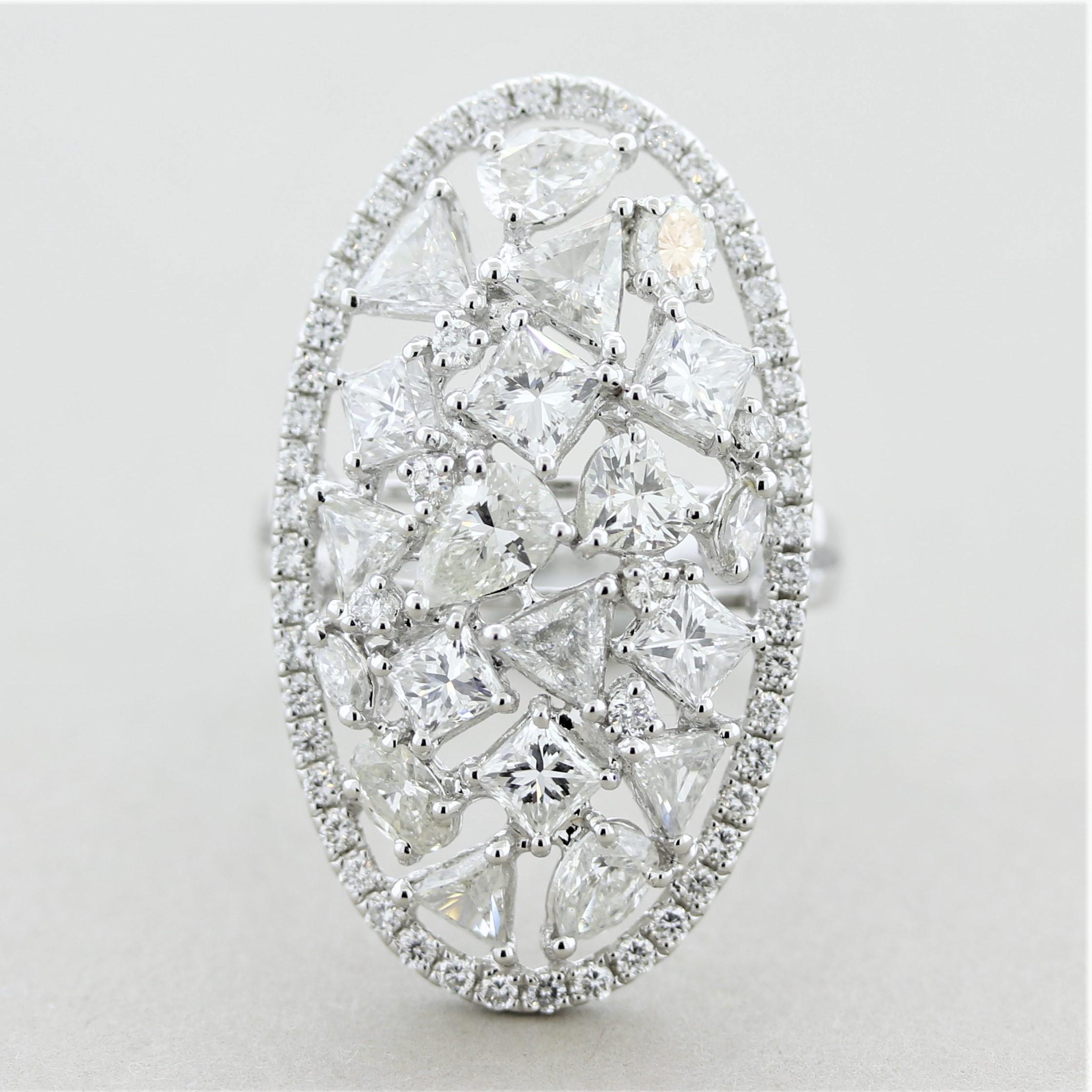 A unique diamond cluster ring featuring large diamonds in almost every shape! They include pear-shape, princess, marquise, oval, triangular and round brilliant-cuts. They are set close to each other creating a big bright cluster. In total the