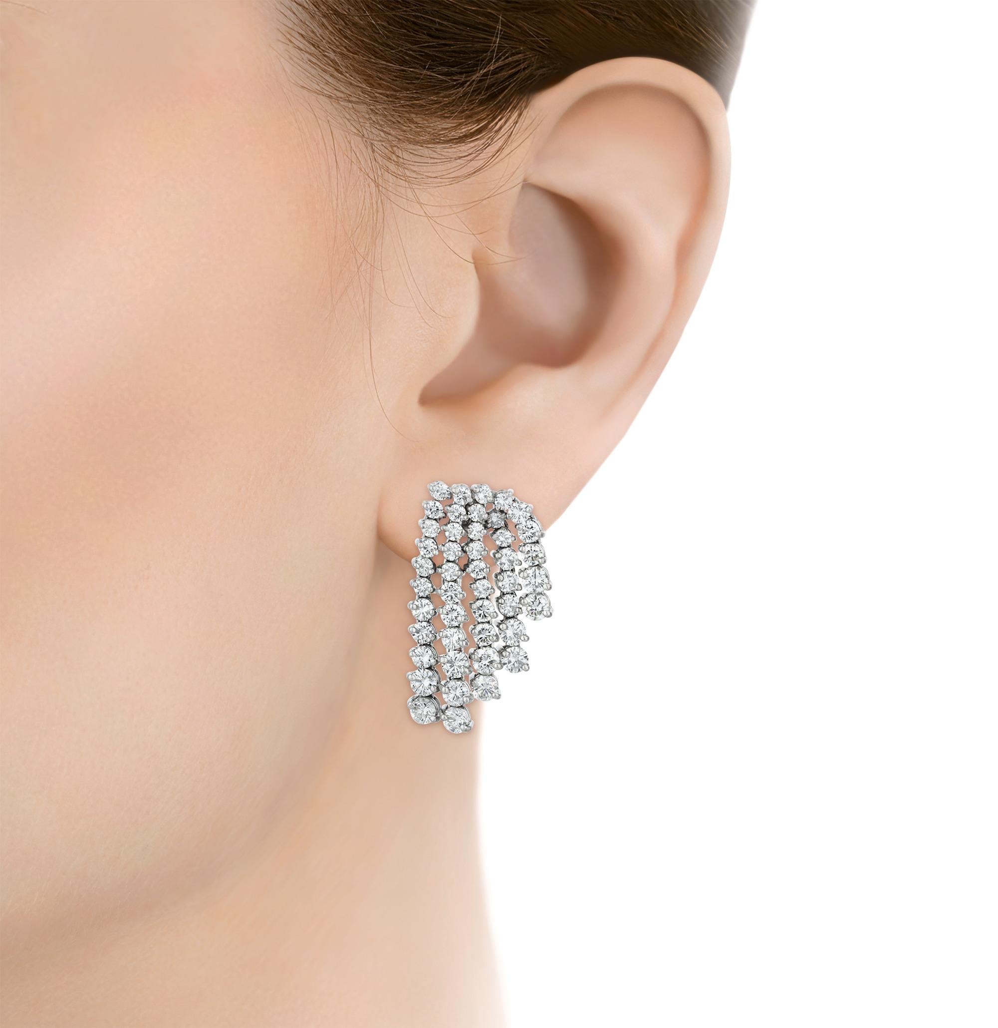 These timeless earrings feature 90 round brilliant cut diamonds of G-I color and SI1-I1 clarity totaling approximately 7.50 carats. The diamonds cascade in shimmering strands meticulously arranged to accentuate the exceptional quality of each