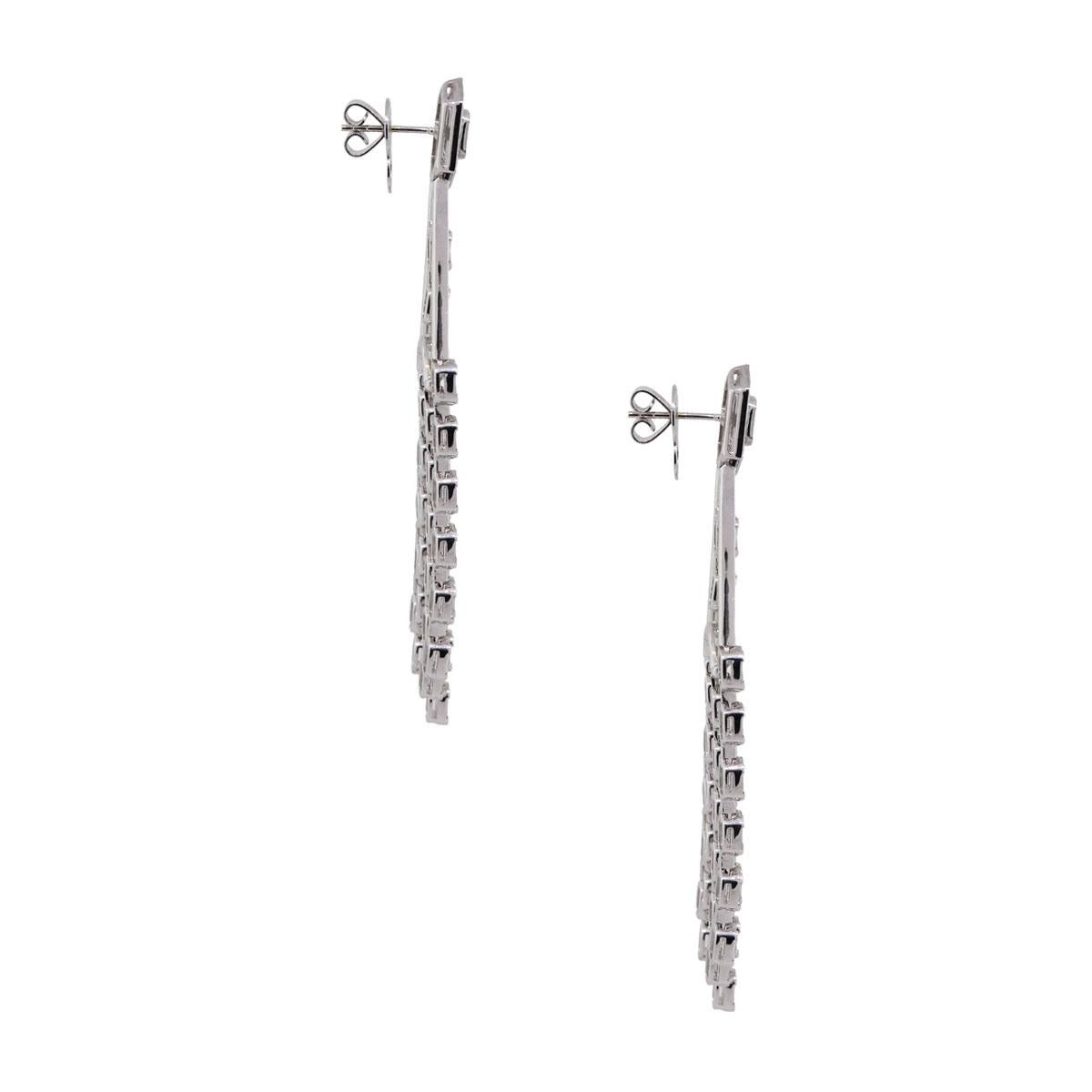 Material: 18k white gold
Diamond Details: Approximately 1ctw of round brilliant diamonds (158 stones). Approximately 10.11ctw of baguette shape diamonds (340 stones). Diamonds are G/H in color and VS in clarity
Earring Measurements: 2″ x 0.17″ x