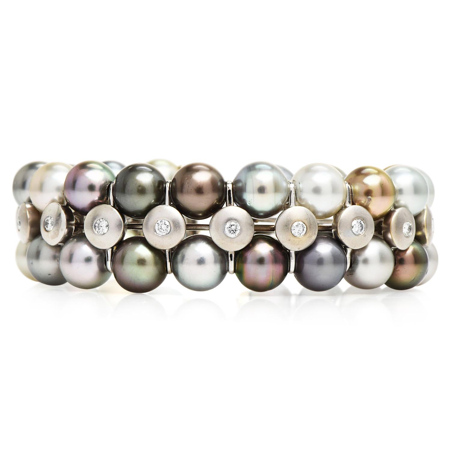 This stuunng cuff has 36  lustrous gray, silver, golden & white Tahitian pearls, With minor blemishes,  measuring 8.5 mm each.

With (17) round-cut, flush bezel set genuine Diamonds weighing approximately 1.40 carats (G-H color and VS clarity)

The