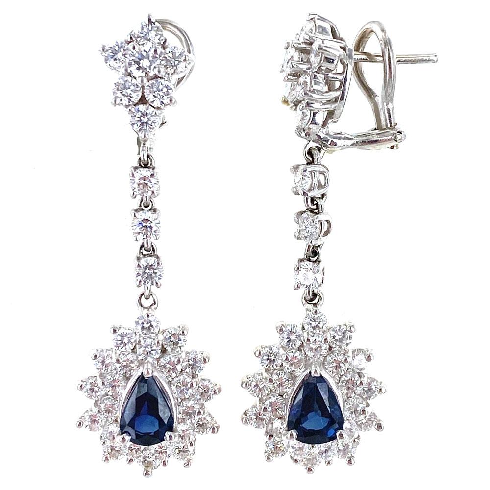 Stunning diamond sapphire drop earrings. These brilliant earrings feature 66 round brilliant cut diamonds weighing 3.50 carats. The diamonds are graded H-I color and VS2-SI clarity. The 2 pear shape natural blue sapphires weigh approximately 2.00