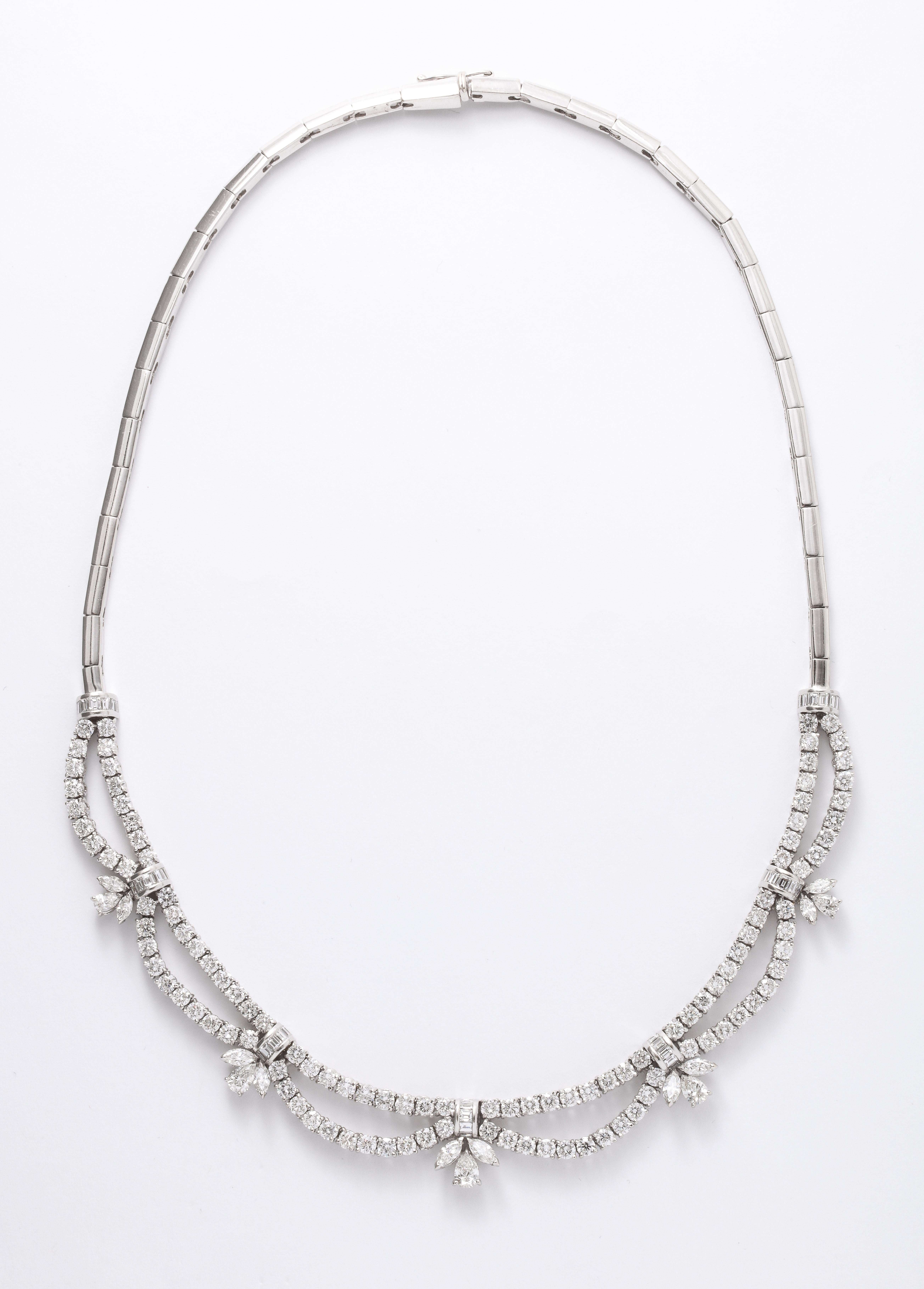 
A beautiful diamond necklace set in a scalloped design featuring round, pear, marquise and baguette cut diamonds. 

17.65 carats of white diamonds set in 18k white gold. 

16.5 inch length 

Designed and made in Italy
