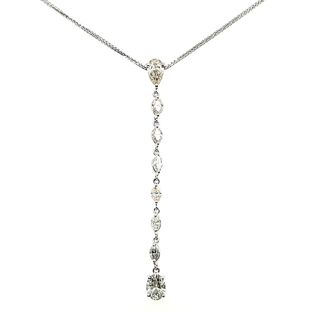 At the core of this exquisite piece are the 2 captivating Diamond Pear and Oval stones, boasting a combined weight of 2.70 carats.

One has a pleasant brownish tinge, and the other is greenish. 

The necklace is further adorned with 6 Marquise-cut